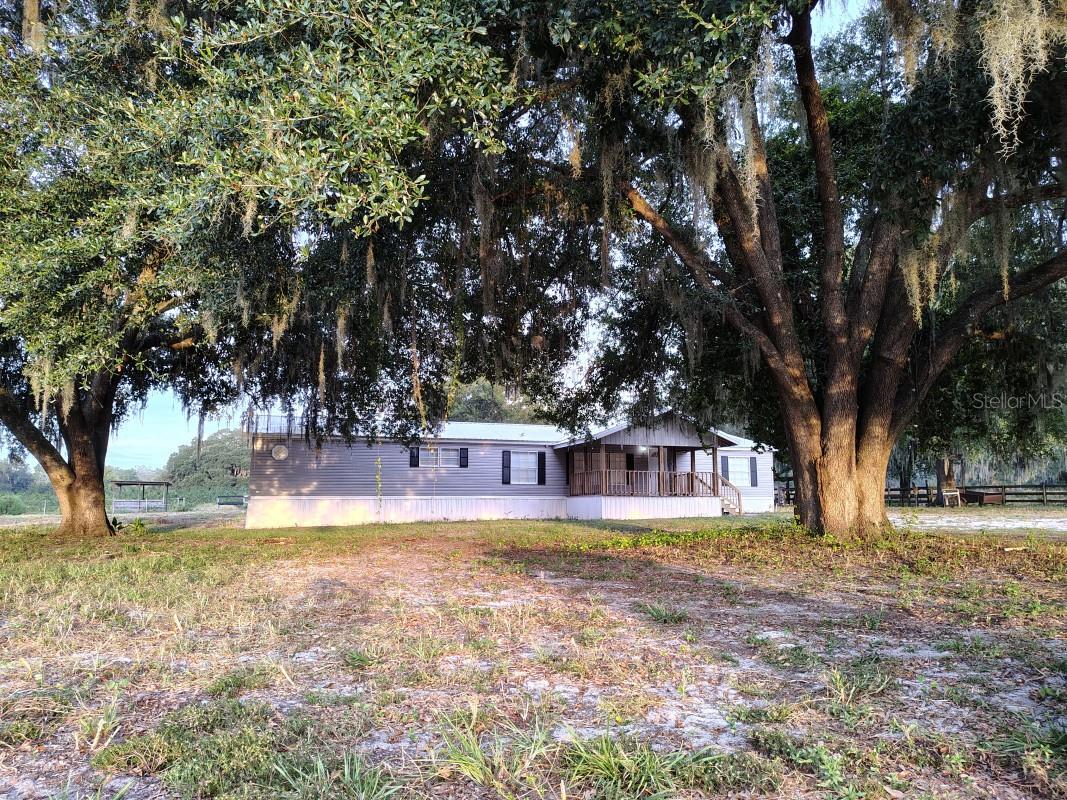 Huge, Like-New 10.25-Acre Horse Ranch in Horse Country! Bring the horses and animals! This exceptionally spacious 4-bedroom, 3-bath, 2,356 sq. ft. home sits on 10.25 beautiful, private acres in a peaceful and secluded country setting.The home has been extensively updated and shows like new, featuring a new kitchen, new appliances, new luxury vinyl flooring, updated bathrooms, newer A/C, and a 2020 metal roof. The generous floor plan offers separate living and family rooms, large bedrooms, walk-in closets, and a wood-burning fireplace.Acreage is ready for horses and livestock, with multiple fenced pasture areas, cross-fencing, a run-in shelter, horse stall, and storage building. Massive mature live oaks throughout the property provide abundant natural shade and shelter for horses and other animals while creating a beautiful, established Florida setting.Located in the Williston/Ocala horse country, with convenient access to HITS Post Time Farm, the World Equestrian Center, equine veterinarians, feed and hay suppliers, tack shops, trainers, and other equestrian services.If you're looking for a large, beautifully updated home with acreage, privacy, established pastures, and room for horses and animals, this property offers a hard-to-find combination.
