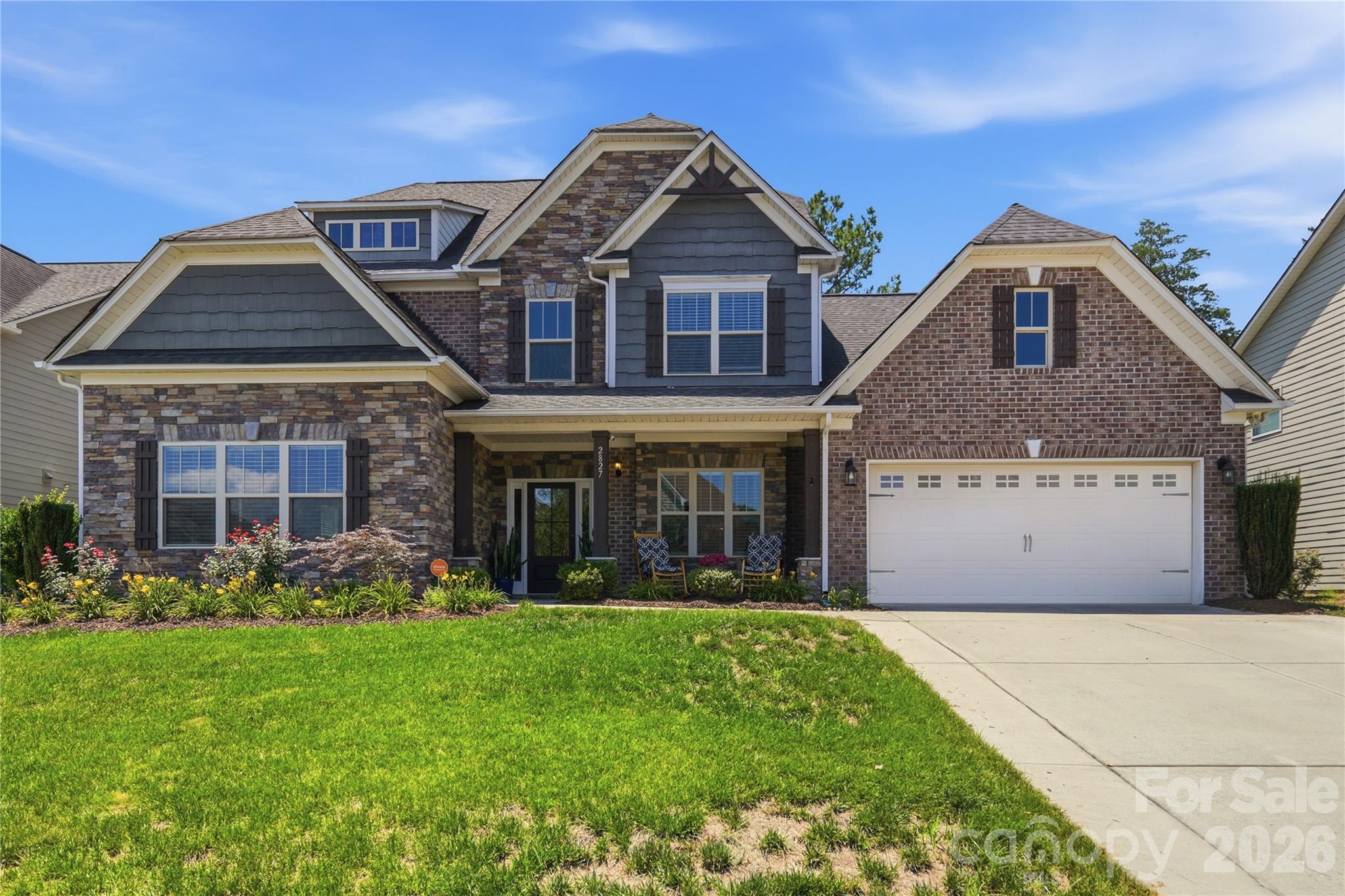 Elite Entertainment and Resort-Style Living in Kellswater Bridge! Nestled on a highly desirable, private cul-de-sac lot backing to a serene backdrop of mature trees, this stunning 5-bedroom, 3.5-bathroom home offers nearly 4,000 square feet of meticulously maintained living space. Step past the covered front porch onto gorgeous hardwood floors that flow seamlessly throughout the entire main level. The heart of the home features a chef’s dream kitchen boasting a massive central island, a brand-new gas stovetop with a premium vented hood, a wall-mounted oven and microwave, a new garbage disposal, and abundant storage.Unwind in the oversized primary suite, conveniently located on the main level, featuring brand-new carpet, a private sitting retreat, and a massive walk-in closet. A beautiful butler's pantry links the living and dining spaces, leading the way upstairs where you will discover a show-stopping bonus space equipped with its own kitchenette, creating the ultimate, elite home theater experience.Enjoy your morning coffee on the screened-in porch or host weekend gatherings on the newly extended back patio inside your private, fenced backyard. Incredible mechanical upgrades and peace of mind come standard, including two brand-new AC units, brand-new windows protected by a lifetime warranty, new gutters with protective screens, and brand-new wooden blinds installed throughout. Complete with a widened driveway that effortlessly accommodates extra vehicles side by side, all of this is just a short walk from Kellswater Bridge’s premier resort-style pool, fitness center, clubhouse, tennis courts, basketball courts, and greenway trail access.
