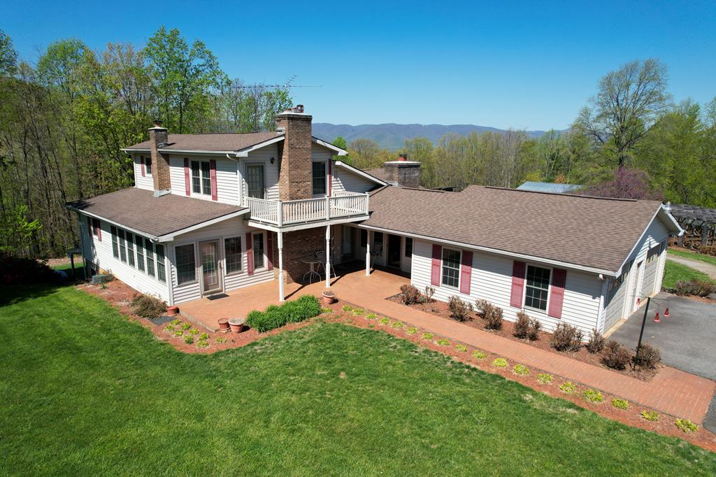 Spacious 1.5Story Country House with partially finished basement and 360 degree views located in Patrick County, VA (4868 Woolwine Highway, Stuart, VA 24171). 3 bedrooms -3 baths. 3,400 sq ft finished. Custom wood work throughout the home including cabinets, doors, flooring, railing, trim and more, very well maintained. Front porch and back deck. 15.94 ac. land is level to rolling. Long Paved Driveway. Main Level: Foyer, Living Room with wood burning fireplace, Dining Room, Kitchen (granite counter top, Gas stove, dishwasher and refrigerator),Bedroom - Laundry Area, Full bath, Master Bedroom.Master Bath, Den/Office with fireplace and Sun Room/Florida Room.The 2nd level serves as a guest suite with a full bathroom, walk-in closet and a private balcony overlooking Bull Mountain. The basement is partially finished and has a full kitchen used as canning kitchen at present and a large game - familyroom area. Unfinished: Large Utility room with storageand a canning room.