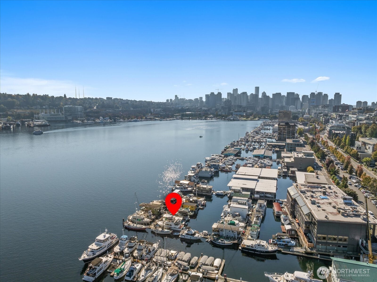 Welcome to Cubana — a stunning, fully remodeled and fully furnished floating home filled with natural light and modern charm. Step inside to a lofted living area with breathtaking Lake Union and city skyline views, a cozy fireplace, and a beautifully updated kitchen with sleek new appliances, quartz countertops, and stylish flooring. The spacious bedroom offers ensuite laundry and a luxurious marble-finished bath with a deep soaking tub. Enjoy two lower decks plus a full rooftop deck with panoramic lake, Gas Works, and downtown views—perfect for morning coffee or sunset gatherings. All decks resurfaced (3/25); hauled-out and bottom-painted (9/23). Easy parking, water/gas/electricity included, pets and rentals allowed. FOWR #715.