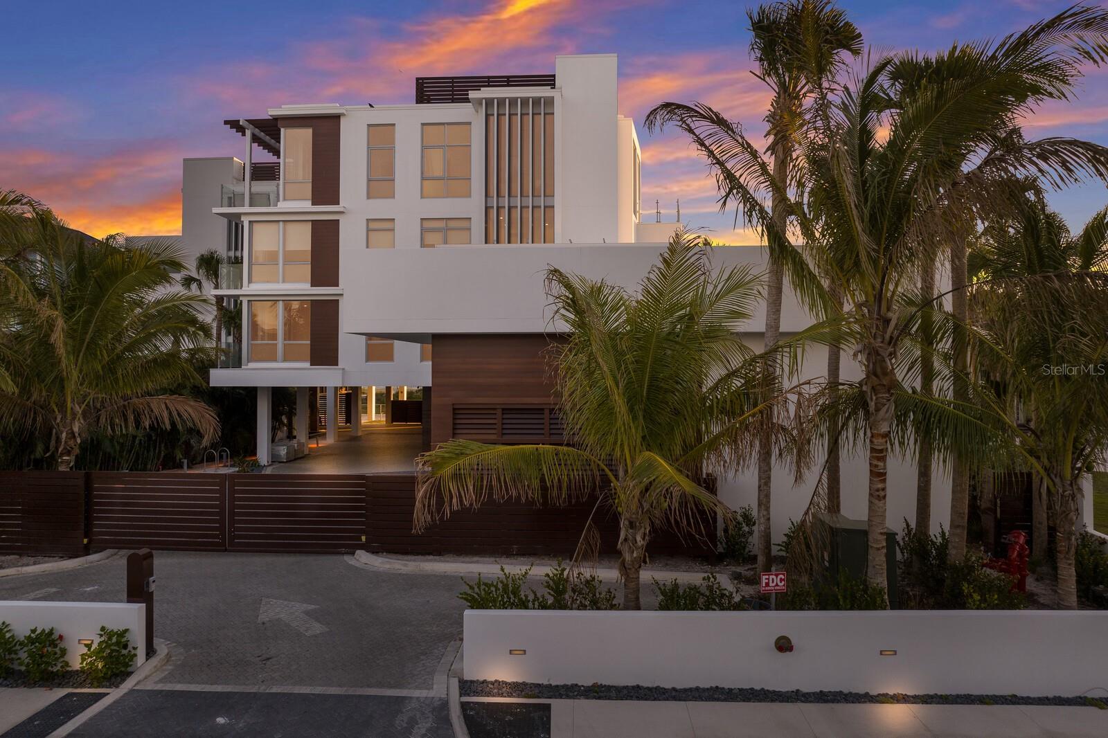 One or more photo(s) has been virtually staged. Experience luxury living at its finest in this breathtaking one-of-a-kind new construction condominium nestled directly on the pristine shores of world famous Siesta Beach. Spanning over 6200 square feet, this exclusive residence offers unparalleled opulence and panoramic views of the azure waters and fiery sunsets. Elegance meets convenience with a private elevator whisking you to your sanctuary above. Park your collection of vehicles effortlessly in the expansive 4-car garage before ascending to your private oasis. Step out onto expansive covered balconies to savor the sea breeze and soak in the mesmerizing vistas. Entertain with flair in the rooftop pool area, complete with a firepit for cozy gatherings under the stars. Your own private beach cabana beckons for tranquil moments by the water's edge, while the gated entrance ensures utmost privacy and security. Indulge in the ultimate relaxation within the heart of Siesta Village, where world-class dining and boutique shopping await a mere two blocks away. Retreat to the comfort of your home office or unwind in the bonus/game room after hosting guests in one of the three en suite guest bedrooms, each offering unparalleled comfort and privacy. Luxuriate in the gulf-front master suite, adorned with ceiling-to-floor windows framing the endless ocean vistas. This is a rare opportunity to own a slice of paradise on  iconic Siesta Key, where every amenity and indulgence awaits at your doorstep.