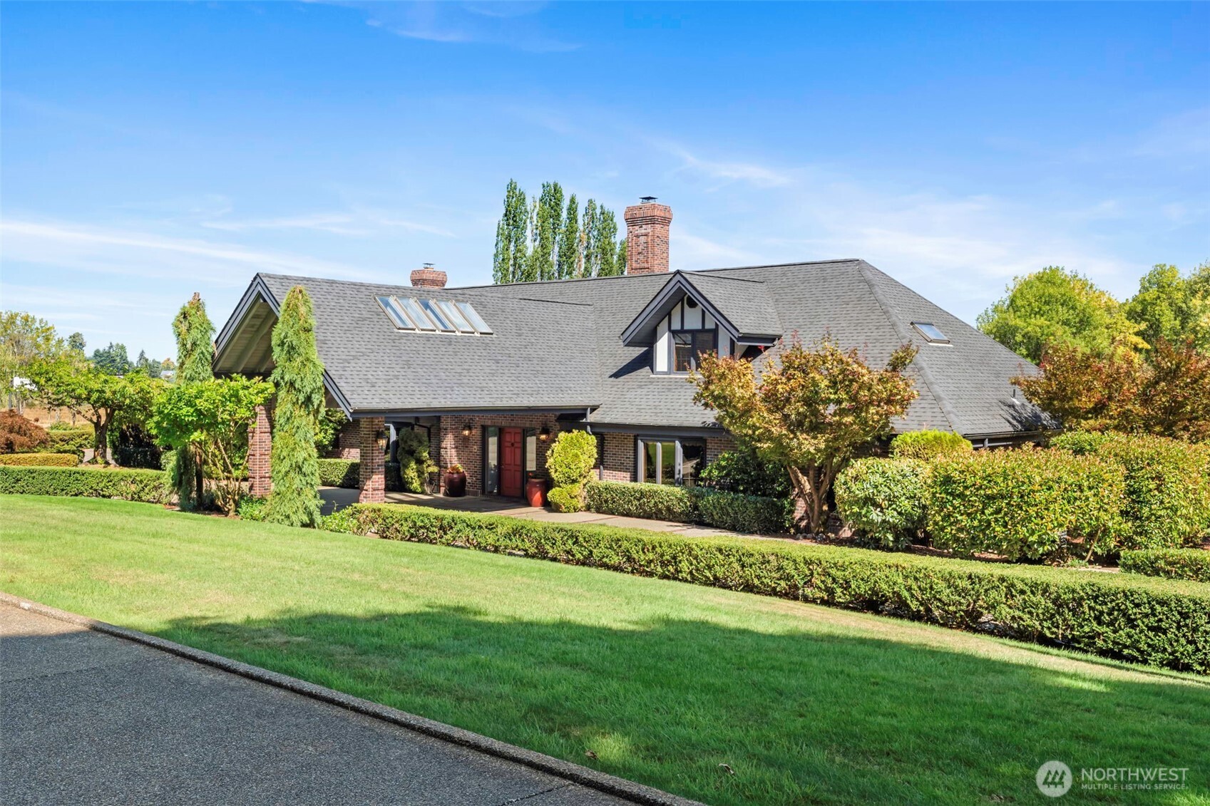 No doubt you have admired this home and property for years.  Set on an exceptional 10-acre estate with a breathtaking view of Mt. Rainier, this stunning custom 5,372 square foot residence is an unparalleled blend of privacy and luxury living.  Thoughtfully designed for both grand entertaining and comfortable everyday living, this beautiful home really offer endless possibilities.  There is space for everyone.  The ADU could be for a caretaker or relatives.  A dedicated wine cellar adds an elegant touch for collectors and entertainers alike.  This remarkable property delivers a very rare combination of luxury, versatility and tranquility.  Stock the pond and share your own private fishing space.  The large 50 X 86 barn will be a great space for your animals, equipment and feed.  Notice the floors and trim, all ash hardwood, custom milled in Tacoma.   The inviting kitchen table space was created just for this home and is included.  There is a laundry chute with custom designed baskets to be included in the sale.  Also notice the granite fireplace in the great room, all river rock from Sun Valley, ID.