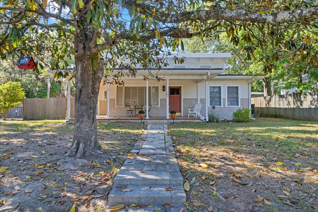 Beautifully updated property featuring a 2BR/1.5BA main home with a charming wraparound front porch. Updated kitchen includes an island with eat-in seating, granite countertops, stainless steel appliances, a wine cooler, and a dining area—perfect for entertaining. Living room with built-in bookshelves. Bedrooms offer updated baths and closets. Covered breezeway leads to a 1BR/1BA carriage house—ideal for guests or rental potential. Fenced yard in a convenient location.