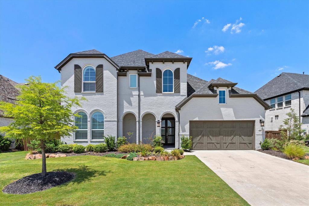 Luxury living in the award-winning Star Trail community—stunning Highland home offers soaring ceilings, a first-floor media room, and a highly desirable multigenerational floor plan in the heart of Prosper. Perfectly positioned in one of North Texas’ most sought-after suburbs and zoned to top-rated Prosper ISD, this exceptional residence blends upscale design with the comfort and flexibility today’s buyers are searching for. Step inside to discover dramatic 21-foot ceilings, extensive hardwood flooring, and a bright open-concept layout designed for modern living and effortless entertaining. The chef-inspired kitchen features quartz countertops, Frigidaire Professional stainless appliances, a five-burner gas cooktop, double ovens, under-cabinet lighting, and a spacious walk-in pantry—all opening seamlessly to the expansive living and dining areas. A wall of windows fills the space with natural light while the elegant gas fireplace creates a warm and inviting focal point. The thoughtfully designed multigenerational floor plan offers multiple bedrooms on the first floor, each with private ensuite baths and walk-in closets. The luxurious primary suite provides a peaceful retreat with a spa-inspired bath and oversized walk-in closet with convenient access to the laundry room. Enjoy cinema-style movie nights in the dedicated first-floor media room, while the upstairs game room offers additional space for entertaining, gaming, or relaxing with family and friends. Step outside to your covered patio with a cozy fireplace—perfect for enjoying Texas outdoor living year-round. Star Trail residents enjoy resort-style pools, clubhouses, tennis and pickleball courts, parks, and miles of scenic walking and biking trails. Conveniently located near the Dallas North Tollway with easy access to Frisco shopping, dining, and the PGA District, this home offers the perfect combination of luxury, lifestyle, and location in Prosper.