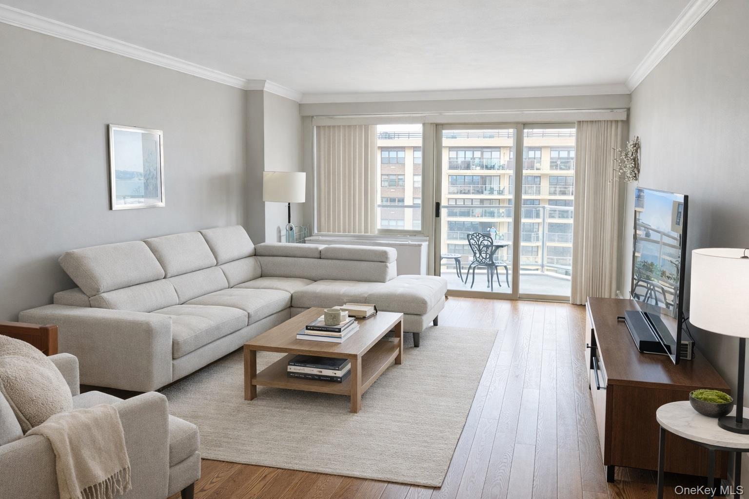 Perched on a high floor (16th floor), this spacious (larger) one-bedroom coop residence offers an exceptional blend of light, comfort, and tranquility. Expansive windows frame sweeping views overlooking Little Neck Bay—where sailboats glide across the water in the summer—creating a picturesque and ever-changing backdrop.The home is filled with natural light, complemented by warm hardwood flooring and well-placed high-hat lighting that enhances both ambiance and functionality. The open-concept living and dining area flows effortlessly, leading to a breathtaking private balcony—an ideal setting for quiet mornings or serene evenings with serene water views.The kitchen is both practical and refined, featuring ample cabinetry and the convenience of two refrigerators, perfectly suited for both everyday living and entertaining. Storage is abundant throughout, highlighted by a generous walk-in closet that provides exceptional organization and space.Residents enjoy a full suite of amenities designed for convenient, elevated living, including an underground parking garage, Olympic-size pool, basketball and tennis courts, party room, gym with workout classes, card room, and a commercial laundry facility. On-site conveniences such as a dry cleaner, deli, and nail and hair salon further enhance daily ease. The building is a luxury elevator property with 24/7 doorman service, offering both security and service.Ideally located, the property provides seamless access to transportation with an express bus to Manhattan and close proximity to the LIRR. A short walk brings you to Bay Terrace’s outdoor shopping and grocery options, while nearby Bell Boulevard offers a vibrant mix of dining, dessert spots, and retail along a lively neighborhood corridor. Base maintenance (inc RE tax, gas, electric, & maintenance) is $1,266.39 with temporary assessments $236.50.  Garage indoor parking $190—optional.  Subject to board approval. SHARES 468. See skyline and sunset photos from the balcony.