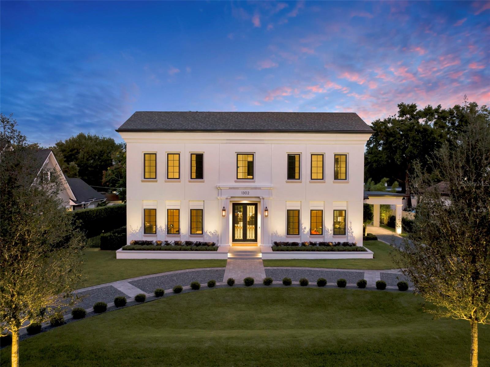 Under contract-accepting backup offers. An expression of modern luxury by SMRS Design and Cole Homes, The Maybourne masterfully blends Neoclassical elegance with Art Deco sophistication—all just steps from Winter Park’s iconic Park Avenue.A curved, manicured driveway leads to a grand entrance featuring bespoke double doors with electromagnetic privacy glass, setting the tone for the artistry within. Inside, a European hotel–inspired foyer greets guests with precast stone-clad walls, inlaid marble flooring, and a Murano-style polyhedral chandelier.Two first-floor guest suites, each with its own bath, are adorned with rift-cut white oak millwork, curved ceilings, and crystal chandeliers. At the heart of the home lies the main salon, where oak detailing and a deco-style stone fireplace with a holographic insert create an atmosphere of understated grandeur.The two-tone oak kitchen, wrapped in natural quartzite and anchored by a curved island and custom hood, features a curated suite of professional-grade appliances:• ILVE range• Miele refrigerator, freezer, and dishwasher• Sub-Zero wine and beverage preservation systemsAdjacent, a dining area glows under a custom chandelier, while the powder bath impresses with wood and marble accents, an integrated stone sink, and a Saint Louis crystal faucet by Kallista.A scullery expands the culinary capability with a chef’s sink, Samsung Bespoke laundry and refrigeration, Wolf microwave drawer, and additional Miele dishwasher—ideal for both entertaining and daily ease.The first floor primary suite, discreetly hidden behind millwork, offers a serene retreat with an opulent closet system and a marble mosaic-clad bathing suite featuring Kohler digital shower technology and MTI tub.Upstairs, two additional ensuite bedrooms, a bonus room with walk-in closet, and a secondary laundry continue the home’s standard of refined luxury.Outdoors, the residence embraces resort-style living with a natural gas summer kitchen, infinity-edge pool, and 360-degree raised glass-tile spa. A two-car garage and porte cochere, both EV-ready, provide elegant utility.Modern conveniences include Lutron HomeWorks lighting and shade prewire, built-in SONOS audio zones, pre-installed speakers, and a commercial-grade Ubiquiti WiFi network ensuring flawless connectivity throughout.A feast for the senses, The Maybourne is more than a home—it’s a statement of artistry and craftsmanship, conceived for the most discerning Winter Park resident.