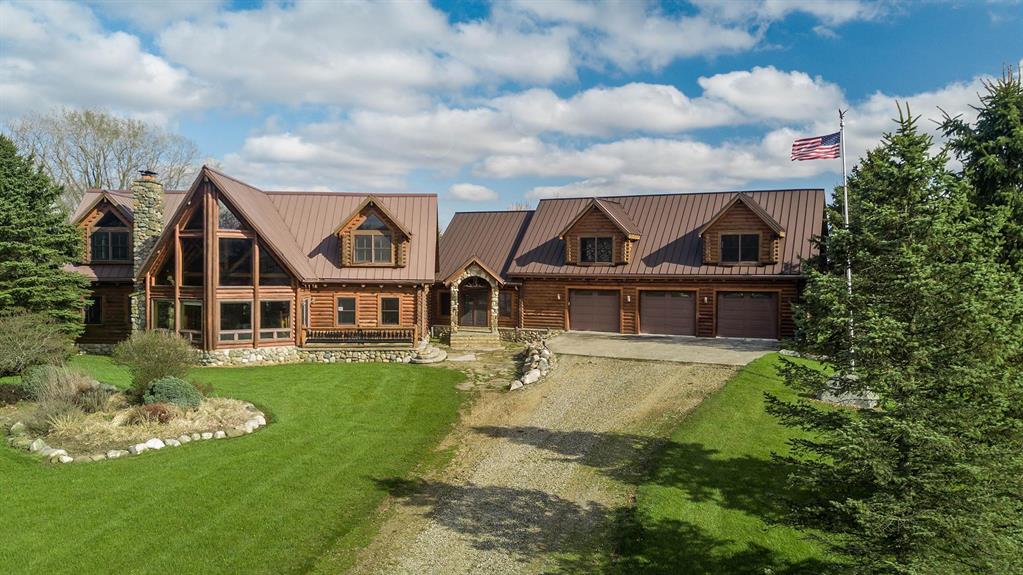 This spectacular home is only one hour from Metro Detroit. Absolutely stunning custom log home. Hand made and hand hued log stairwells, Everything in this estate shows pride of ownership, the owners spared no expense from the gorgeous finished wood bar in the lower level to the custom light fixtures and hand carved french doors in the main residence Touring this home is a adventure where you will discover a secret wine cellar hidden behind a false book case, a beautiful hand finished bar and 2nd kitchen in the lower level. Warm yourself in front of the massive lower level gas fireplace while you relax in the huge family room. The lower level offers a full bath and separate bedroom. When you arrive in the entry level you are greeted with a open floor plan with plenty of room for dining and cooking with a second fully functional kitchen. there are also 2 oversized bedrooms and two full baths that will amaze you.  Walking up the custom hand hued log stairway to the upper level you will discover  2 more full custom bedrooms and baths that also offer some beautiful hand carved woodworking. The vaulted ceiling is truly a marvel to see. Look for the murphy beds that fold into the wall.   The 9" logs and oversized windows add a touch of elegance. As you depart the main home through the heated walkway to the adjoining garage you will discover a elevator that allows you access to all three levels of the home and garage. The lower garage level provides a side access and plenty of room for vehicle storage. The entry garage level has 3 doors and parking for multiple vehicles as well as access to the breezeway connecting the residence. The upper garage level is accessible via a custom log stairwell or elevator. When you enter you will access a 30' X 50' finished conference / banquet area perfect for entertaining, or any large gathering.  When you explore this home be sure to look for the ghosts lurking in the hallways, I can assure you they are friendly This property is a sportsmans delight, a beautiful corporate retreat, or a