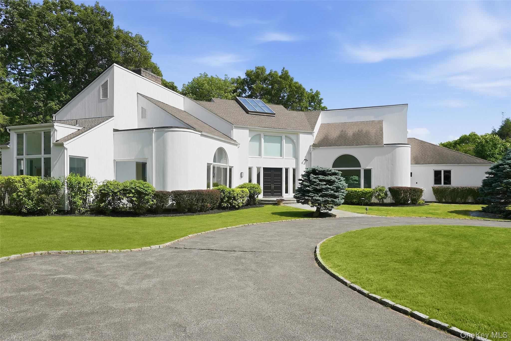 Privately sited at the end of a cul-de-sac close to downtown Armonk, this modern residence is a masterful expression of design, scale, and light. Conceived for sophisticated living and exceptional entertaining, the residence showcases soaring 13-foot ceilings, grand open spaces, and dramatic walls of glass that create a seamless connection between the interior and its breathtaking natural surroundings.The home provides gallery-like interiors ideally suited for the display of fine art, while maintaining a warm and inviting atmosphere. Every room is thoughtfully proportioned and flooded with natural light, creating a sense of effortless elegance throughout. Resort-caliber amenities include a sparkling pool and spa, tennis court (needs restoration) and expansive outdoor spaces. Offering the tranquility of a secluded retreat with the convenience of a premier location, this exceptional property is just moments from town, schools, transportation, and all the amenities of refined suburban living.