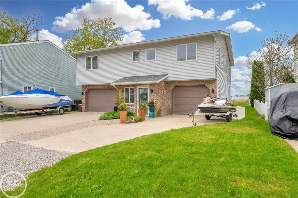 Enjoy endless fun on the water! Check out this one-of-a-kind, turnkey, modern lakefront home - a true showstopper with nothing left to do but move in. This stunning property features numerous recent updates and upgrades, starting with a gorgeous gourmet kitchen complete with a waterfall island and high-end appliances. The home has been freshly painted throughout and boasts all new flooring. The primary suite includes a luxurious en-suite bath, and the fully finished walkout basement offers an additional full bathroom - perfect for entertaining. You'll also love the spacious 3.5-car garage, all-new landscaping, and of course the breathtaking lake views from both the great room and bar area as well as the custom deck and patio area, also beatiful hot tub is also included. - the perfect spot to enjoy sunsets over the water. Unlike most homes on the lake in this price range that require major renovations, this one is move-in ready - everything has been done for you! -