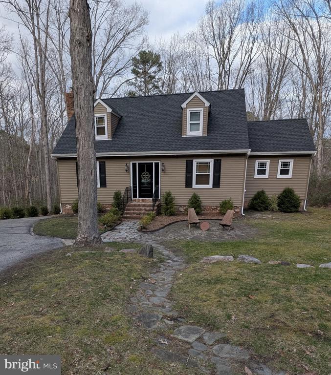 COMING SOON!  PROFESSIONAL PICS COMING SOON.   Charming Cape Cod in a Private Lake Community! Welcome to 42 Mockingbird Way, a beautifully updated home set on 1.6+ peaceful acres that feels like a year-round retreat. A long winding driveway offers parking for 8+ cars and a serene, nature-filled setting. The exterior was completely redone in 2020 with new siding, windows, roof, and more.Inside, you’ll find neutral paint, recessed lighting, refinished hardwood floors, tile, and newer HVAC. The spacious living room features a bright bay window and an Avalon wood-burning stove, while the formal dining room is ideal for gatherings. The eat-in kitchen offers granite countertops, stainless steel appliances, and abundant cabinetry, and opens to a laundry area, updated half bath, and a heated sunroom overlooking the expansive backyard. Step outside to the oversized deck and enjoy the cleared yard plus wooded trails for ultimate privacy.Upstairs are three comfortable bedrooms with hardwood floors and an updated full bath, along with a walk-up attic for additional storage. The large basement offers great potential for finishing and includes garage access. The garage is currently being used as a bright pottery studio, featuring a full sliding glass door; however, the original garage door has been saved, allowing the next owner to easily convert the space back to a traditional garage if desired.Recent updates include: new hot water heater (2023); in 2024—sellers added a  utility sink and water in garage/workshop, upgraded 240V electrical outlets, new water softener filtration tank, 6×4 corrugated metal shed, and outdoor playground/garden; in 2025—garage door replaced with a full sliding glass door; and a NEW heater installed February 2026.Located in a sought-after lake community with beach and swimming access, excellent schools, and convenient proximity to Philadelphia and the Jersey Shore, this home offers space, updates, and tranquility in one exceptional package. Schedule your showing today!