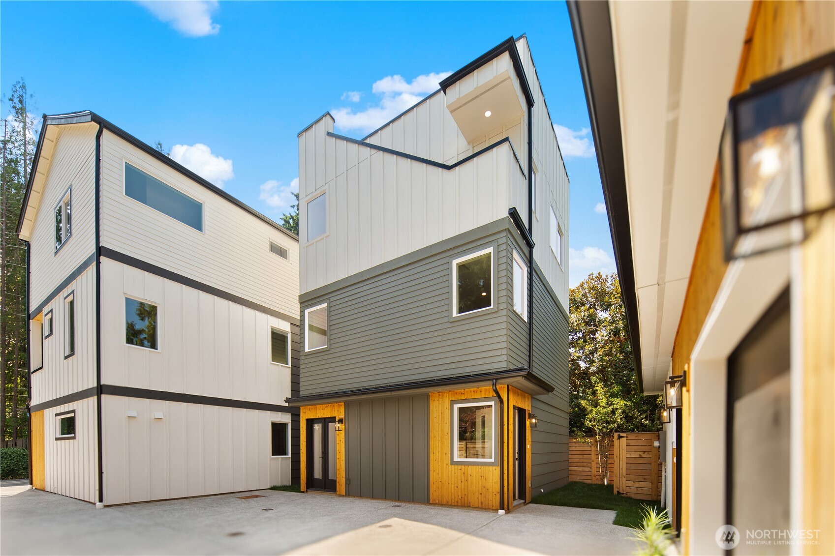 A fresh take on North Beach living, this brand-new detached home offers a smart vertical layout and a rare neighborhood perk: the option to join North Beach Club for access to a private, member-only stretch of Puget Sound beach. The entry level features a bedroom and bath, offering flexibility for guests, a home office or additional living space. One level up, the kitchen, living and dining areas come together in an open layout anchored by an electric fireplace. The top floor is reserved for the primary suite with an ensuite bath, creating welcome separation from the main living areas below. Above it all, a rooftop deck captures Puget Sound views and provides a scenic place to unwind or entertain. A dedicated scooter garage adds convenient storage, while an assigned, uncovered EV-ready parking space makes off-street parking easy. Modern and efficient, this is a distinctive opportunity to enjoy new construction in one of Seattle’s most desirable residential neighborhoods.