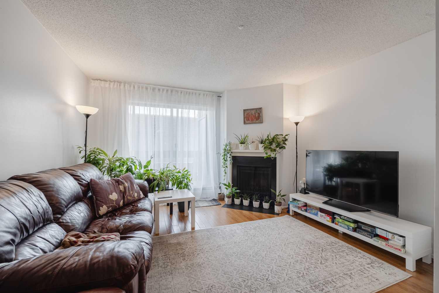 Experience the perfect blend of comfort and convenience!  This 2 bedroom, 1 bathroom, corner condo features larger rooms than typically found at this price point, and maximizes every square foot. The light-filled, open-concept living area is anchored by a central fireplace and extends to an oversized balcony that’s ideal for morning coffee or container gardening. Additional perks include a secure private storage room and excellent complex amenities, including a social room, games room, indoor racket court, fully equipped gym and outdoor basketball/tennis courts. Being perfectly positioned only minutes from shopping, restaurants, parks, playgrounds, schools and major transit routes, you have found the one!  Make it yours before someone else does!