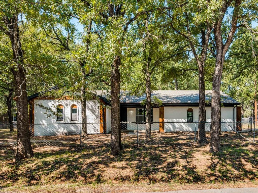 BEAUTIFULLY REMODELED CORNER LOT HOME IS MOVE IN READY! This home has been updated with ALL NEW roof, windows, HVAC, wood flooring, carpet, granite, stainless steel appliances, paint inside and out, plumbing and light fixtures, tile and MORE. Walk into the open living are with a fireplace. Then there is a formal dining right off the living area. The kitchen is like brand new with a subway tile backsplash. The master suite features a barn door and a walk in shower. There is a sunroom off the back of the house and plenty of garage space. The property is heavily treed and provides ample shade. The lot next door MLS #21056921 is listed for sale at $59,000. OR you can buy both the lot and the house together for just $289,900. Both lots together total just under half an acre. The extra lot that can be included features a gated in fenced area and a HUGE covered storage building that can be used to park cars, boats or an RV.