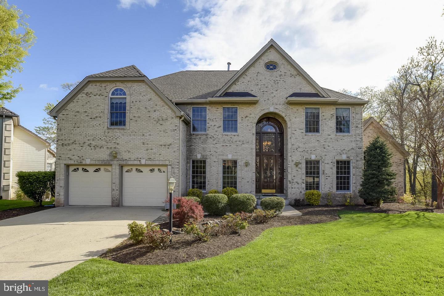 Absolutely spectacular estate situated on a premium lot backing to a serene, wooded common area.From the moment you arrive, the dramatic two-story grand marble foyer—anchored by a stunning 22-foot stained-glass front door and a floating staircase—sets a breathtaking tone. The main level is designed for both grand entertaining and intimate living, featuring a light-filled, two-story expansive family room accented by rich champagne oak paneled walls and a massive wet bar. Work from home in style in the gorgeous executive study, complete with a custom-lit domed ceiling and rich wood paneling. The chef’s dream kitchen boasts custom cabinetry, premium high-end appliances, and ample prep space.Retreat to the rarely available main-level primary suite, a private sanctuary offering a dramatic sitting room, soaring vaulted ceilings, and a cozy fireplace. The spa-like marble ensuite bath features an elegant cathedral ceiling.Upstairs, you'll find four generously sized bedrooms, an additional sitting room, and a separate gallery area perfect for art or reading. The walk-out lower level offers endless potential, while the massive custom rear deck overlooks a beautifully manicured backyard, mature woods, and your very own fruit trees (plum and persimmon).