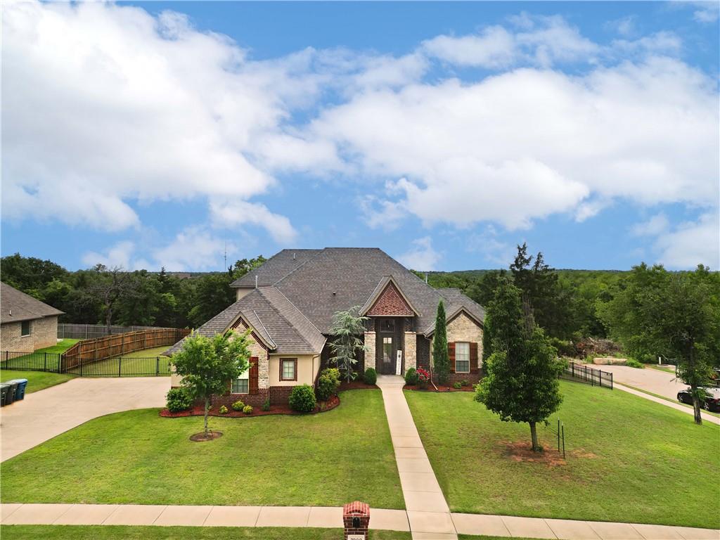 Step into timeless elegance with this luxurious 4-bedroom, 3.1-bathroom home featuring an office and theater room, located in the exclusive gated community of Thunder Canyon in Edmond, Oklahoma. Set on nearly half an acre at the corner of a quiet street, the home’s striking stone accents and custom shutters create unforgettable curb appeal. Inside, you’re greeted by soaring ceilings and a grand hallway that leads to a stunning staircase, offering a glimpse of the style and space this home provides. Upstairs, you’ll find a private fourth bedroom and a full theater room—perfect for movie nights or guest accommodations. Designed for both entertaining and everyday comfort, the open-concept living area features vaulted ceilings, a dramatic stone fireplace, and large windows that bathe the space in natural light, with a new AC unit as of Sept 2024. The gourmet kitchen is a showstopper with a massive granite island, shimmering glass tile backsplash, double ovens, and a huge walk-in pantry—ideal for the home chef. Two spacious bedrooms downstairs share a Jack and Jill bathroom, while a convenient half bath off the hallway serves guests with ease. The master suite is truly exceptional, highlighted by tray ceilings and a spa-inspired en-suite bathroom featuring granite countertops, dual vanities, a sauna-style walk-in shower, whirlpool tub, and an oversized custom closet with built-in cabinets and shoe racks. Additional conveniences include a laundry room with utility sink located just off the garage. Hang out on the your large covered patio, that boasts new ceiling fans for a cool breeze. Thoughtfully designed and meticulously maintained, this home offers luxury living close to I-35, shopping, and top-rated schools—all in one of Edmond’s most desirable communities. If you are looking for a change, look no more! This wonderful home is ready for a new owner! Buyer to verify schools.