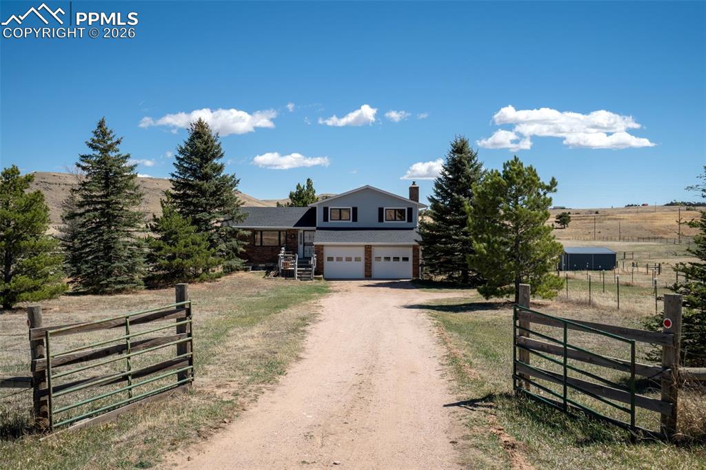 Welcome to 12360 Mesa View Road, where 10 acres, sweeping Front Range views, and a glimpse of Pikes Peak make it really hard to think about anywhere else. Fully fenced and cross-fenced, this property is basically a horse lover's dream checklist: 3 pastures, a large paddock, a 528 sq ft 2-stall barn, a hay barn, and a storage shed, all backed by 40 acres of open space, because your horses deserve a view too. And with two beautiful riding trails less than 5 miles away, the adventure doesn't stop at the fence line. Inside, the layout works for real life-all 3 bedrooms tucked together on the upper level, a main floor living room and kitchen for everyday living, and a cozy family room with a propane gas fireplace and built-in bar surface (aka your new favorite spot come winter). Step outside onto the gorgeous multi-level deck and into a large, fully fenced yard that's ready for whatever you've got planned. Downstairs, the basement offers flexible space with room for a home office and a generous craft room with plenty of storage. Wide open skies, room to roam, and a home that works as hard as you do: Mesa View Road is ready for its next chapter.