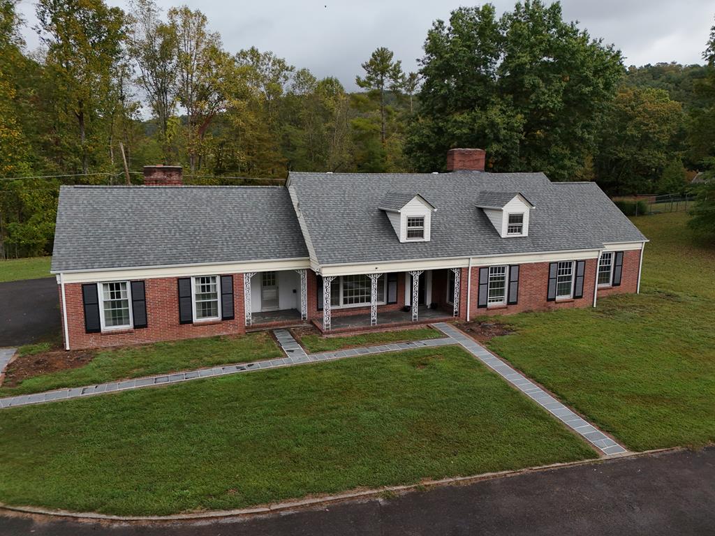Stately CUSTOM-BUILT 1958 Cape Cod style home sitting on 1.78 acres w/ 2-car detached garage in one of the most sought-after neighborhoods in Tazewell County. A ONE-OWNER home was built w/many of the amenities required for a spacious home. The beautiful oak floors in most of the rooms has been well maintained. The first floor has a nice foyer, large living room w/a wood-burning fireplace, formal dining room w/a swinging door that enters the eat-in kitchen. The kitchen has lots of cabinets w/an island, double ovens, cooktop, stainless fridge, & a pantry. Just around the corner from the kitchen is the laundry area that includes a washer/dryer w/cabinets above. The family room has another brick fireplace w/raised brick hearth, pegged wood floors & a sliding door to a large covered screened porch. There are 4/5 bedrooms & 4 1/2 baths. On the first floor there are 2 bedrooms - one is a primary suite w/3 closets, two oak cabinets that remain, private bath w/tub & separate shower, double vanity & vintage tile. There is a half bath and the stairs are rear entry. The second bedroom is an ensuite with a double closet & private full bath w/tile shower (again, another vintage bath). The rec room is on the opposite side of the house and has incredible space - well over 500 sqft with a 3rd fireplace! It's definitely large enough for a pool table & other gaming tables or entertainment areas. Upstairs is spacious - two additional ensuite bedrooms with full baths, an office, a heated BONUS room & large walk-in  space & a loft area w/built-in bookshelves & again, tons of storage! The windows are storm windows!  There's a NEW ROOF & GUTTERS & two heat pumps provide the heating/cooling. The electric service was just updated! There is a basement that once housed a furnace. Outside this home is brick & has a large paved driveway & great parking. There is so much opportunity with this home & it could be brought back to life to an original state! This property is being sold AS-IS.