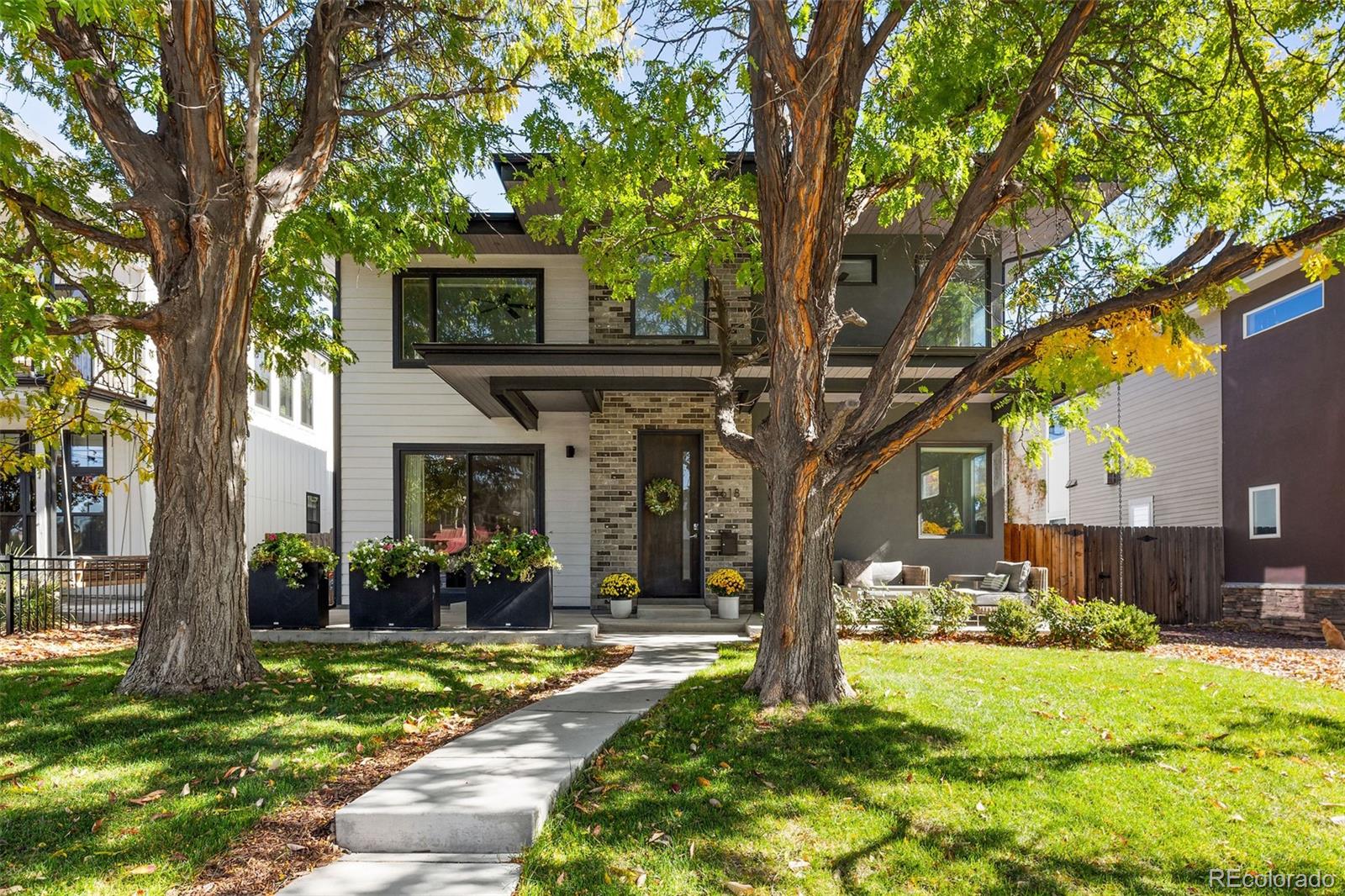 Warm and welcoming, this modern Cory-Merrill home features an expansive open floor plan flooded with natural light throughout. With high ceilings and hardwood floors that carry throughout the main floor, you’re welcomed into the dining room and spacious new kitchen, located at the heart of the home. Renovated in 2025, the kitchen features new Moroccan Zellige tile backsplash, quartz countertops, and new lighting, as well as KitchenAid range, dishwasher and refrigerator, creating a sophisticated space ready for any cook. With room for many, the white oak 10-foot island provides enough counter space for socializing or meal time. Just off the kitchen is a cozy breakfast nook with built-in banquette seating, as well as a walk-in pantry and a separate mini bar area for entertaining. The great room features a 2-way fireplace that looks over the backyard patio, perfect for summer nights out or warm nights in. A generous mudroom with built-ins provides “catch-all” space for shoes and jackets, and a private main floor office is perfect for any work-from-home days. Upstairs, a large primary suite with a private deck, fireplace and luxurious 5-piece bathroom looks over the backyard. Three additional bedrooms upstairs offer flexible living space, a full bathroom and separate laundry room with washer, dryer and storage. The well-appointed lower level includes an additional bedroom and bath, large gym, and a grand rec/media room flex space with an L-shaped bar, dishwasher, and fridge – perfect for game days or movie nights. With four bedrooms upstairs, this centrally located property is a unique gem – just minutes to both Cory Elementary, C3 and Merrill Middle schools and a quick drive to Cherry Creek North or I-25. This home wonderfully marries clean, modern living with warm, inviting design.