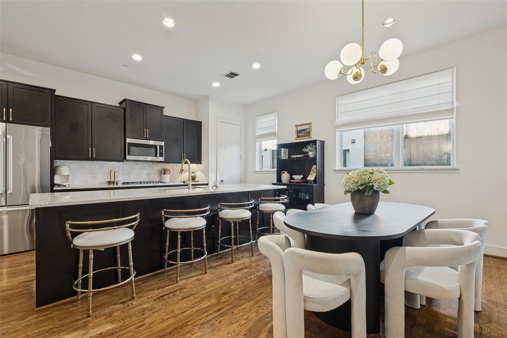 Welcome to this beautifully updated three-level townhome in Oak Lawn, offering 3 bedrooms, 3.5 baths, and a private two-car garage. Tucked into a quiet interior location, the home opens onto the central courtyard, with convenient access to the community pool and grilling area.There are designer updates and pristine hardwood floors on every level. The first-floor bedroom has an en-suite bath and offers flexible space for guests or a home office. On the second floor, you will find light-filled, open-concept living and dining areas anchored by a chef-ready kitchen featuring a large island with bar seating. The effortless flow between the kitchen, counter seating, and dedicated dining space creates the ultimate setting for entertaining. The kitchen pairs granite countertops and an oversized island with a refreshed backsplash and a Bosch appliance suite installed in 2025.Step out from the second-floor living room onto your private balcony, offering tranquil, elevated views near the resort-style pool—the perfect backdrop for morning coffee or an evening cocktail.Upstairs, the primary suite features two walk-in closets and a spa-inspired bath. A third bedroom with its own en-suite bath offers additional flexibility for guests, a nursery, or an office. Enjoy Oak Lawn dining and nightlife, with Whole Foods nearby. Take a walk through Perry Heights to Craddock Park, or enjoy convenient access to Highland Park, Turtle Creek, Uptown, the Katy Trail, the Dallas North Tollway, UT Southwestern and the Medical District, Love Field, and Downtown Dallas. From casual neighborhood brunch spots and cozy wine bars to five-star fine dining in nearby Turtle Creek and Uptown, top-tier dining options are just moments away. Don’t miss this 3-bedroom gem.