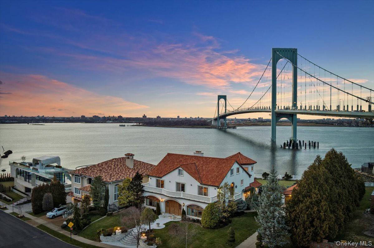 Situated on a serene half-acre waterfront lot, this magnificent 6,500-square-foot residence showcases exceptional craftsmanship and luxury. Built with durable concrete and block construction, the home features stunning ENJO Architectural Millwork throughout, beautifully complemented by rich Kentucky Oak and Carrara marble floors.Designed for both comfort and sophistication, the home boasts 15 thoughtfully curated rooms, including a gourmet eat-in kitchen with a center island, a formal dining room, a formal living room, a den, a sunken sitting room, an office, and seven bedrooms—four of which are en-suite—along with a total of nine bathrooms. The third floor has separate living quarters which may be accessed through a private staircase.Outside, enjoy 128 feet of breathtaking waterfront views in a tranquil setting. A private driveway leads to a spacious six-car garage, adding to the home’s convenience and exclusivity. If you prefer boating, park your boat at a nearby slip.