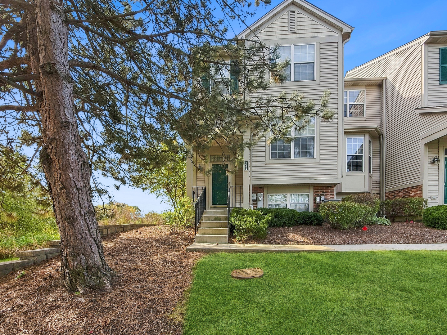 POND VIEWS RIGHT OUTSIDE YOUR DOOR! Imagine starting your morning with a cup of coffee, looking out over the peaceful pond, watching the wildlife, and enjoying the beauty of nature right outside your home! Welcome to 1071 Ellsworth Drive, where the VIEW truly steals the show! Whether you're relaxing on your deck, enjoying dinner, or simply looking out the window, the beautiful water views provide a peaceful backdrop to everyday living. And the inside is just as inviting! This beautifully updated home offers 2 bedrooms, a spacious loft, an additional room in the English basement, and 2.5 bathrooms. Freshly painted with ALL flooring replaced in 2025, this home is ready for you to move right in! The kitchen features gorgeous quartz countertops and backsplash, stainless steel appliances, and updated lighting. The refrigerator, range, dishwasher, and microwave were ALL replaced in 2024! The dining area is filled with natural light from multiple windows and sliding glass doors leading to the deck, where those wonderful pond views take center stage. Upstairs, the spacious loft offers endless possibilities for a home office, additional living space, or your own quiet retreat. The English basement provides even more flexibility with an additional room perfect for a hobby space, workout area, or home office. The primary bathroom was beautifully remodeled in 2022, and additional improvements include a new garage door (2024) and hot water heater (2022). But what truly sets this home apart is its setting. The pond, mature trees, and changing seasons create a beautiful view you'll never get tired of. Why settle for an ordinary backyard view when you can enjoy the beauty of the water right outside your home? Come experience 1071 Ellsworth Drive for yourself. The updates will impress you, but the VIEWS will make you want to stay!