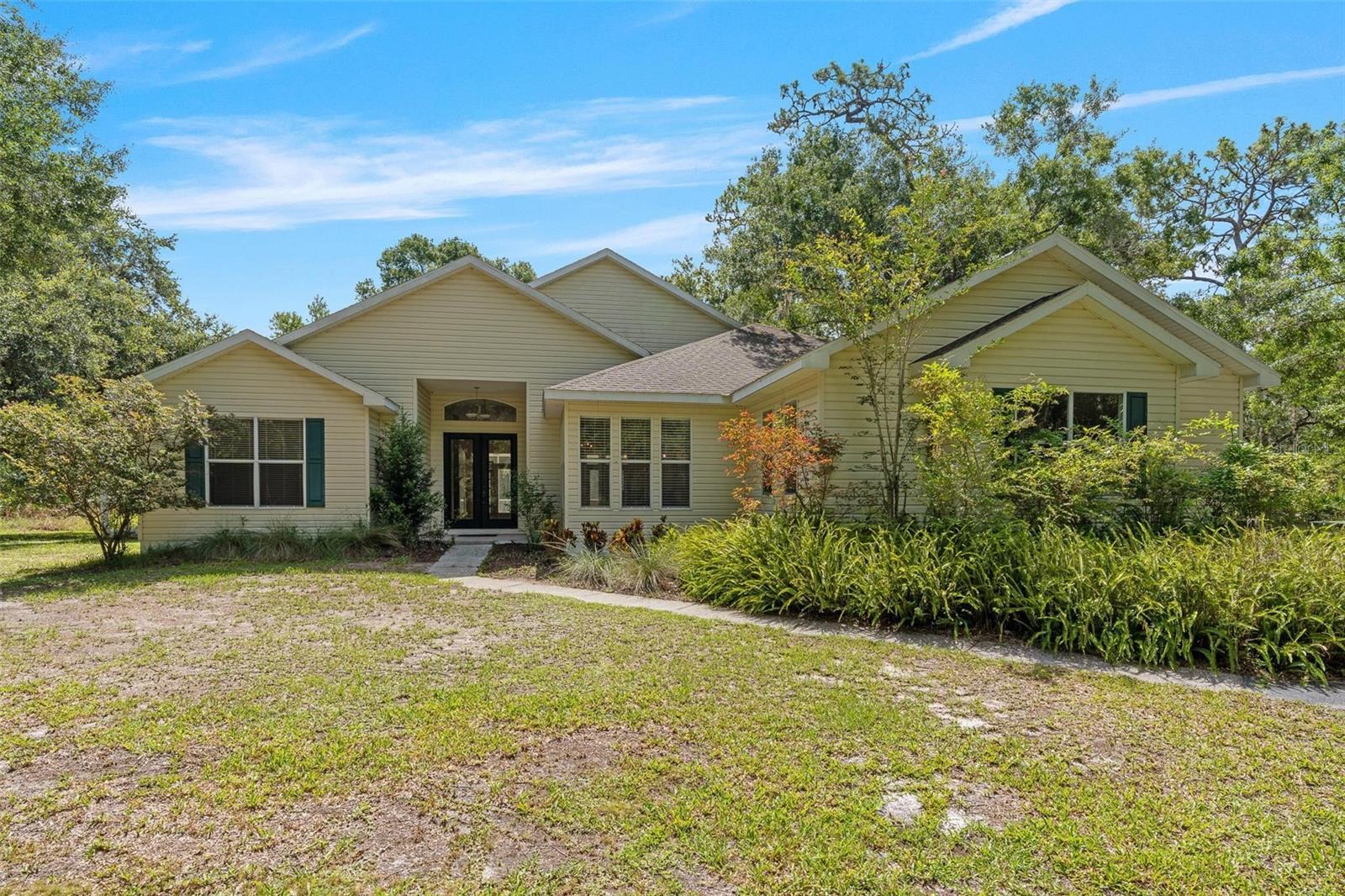 Discover the peaceful lifestyle you've been dreaming of in Pasco Trails, a hidden gem tucked away from the hustle of Pasco County’s expanding suburbs. This gated equestrian community spans nearly 800 acres and includes a private 25-acre nature preserve with two resident-only fishing ponds, perfect for those who cherish privacy, nature, and room to roam.

Each home in Pasco Trails sits on its own acreage with paved roads throughout, creating a tranquil, spacious environment ideal for families, pet lovers, and equine enthusiasts alike. With no CDD fees and low HOA costs, this community offers both value and freedom.

Nestled on 13 picturesque acres, this custom-built home from 2002 features 4 bedrooms, 2.5 bathrooms, and a 2-car garage. Inside, you’ll find warm wood floors, a cozy fireplace, and an open layout that’s perfect for both entertaining and everyday living. The kitchen is a standout with granite countertops, stainless steel appliances, and a center island that makes meal prep a breeze. The split-bedroom floor plan provides privacy and comfort for the whole family.

Step outside to a spacious screened patio, an ideal spot to sip your morning coffee or unwind in the evening as deer and other wildlife pass through your backyard.

Ideally located near I-75 and the Suncoast Parkway, Pasco Trails offers quick access to Tampa while still providing the peace and beauty of country living. Come see this one-of-a-kind property and experience the charm of Pasco Trails for yourself—schedule your private tour today.