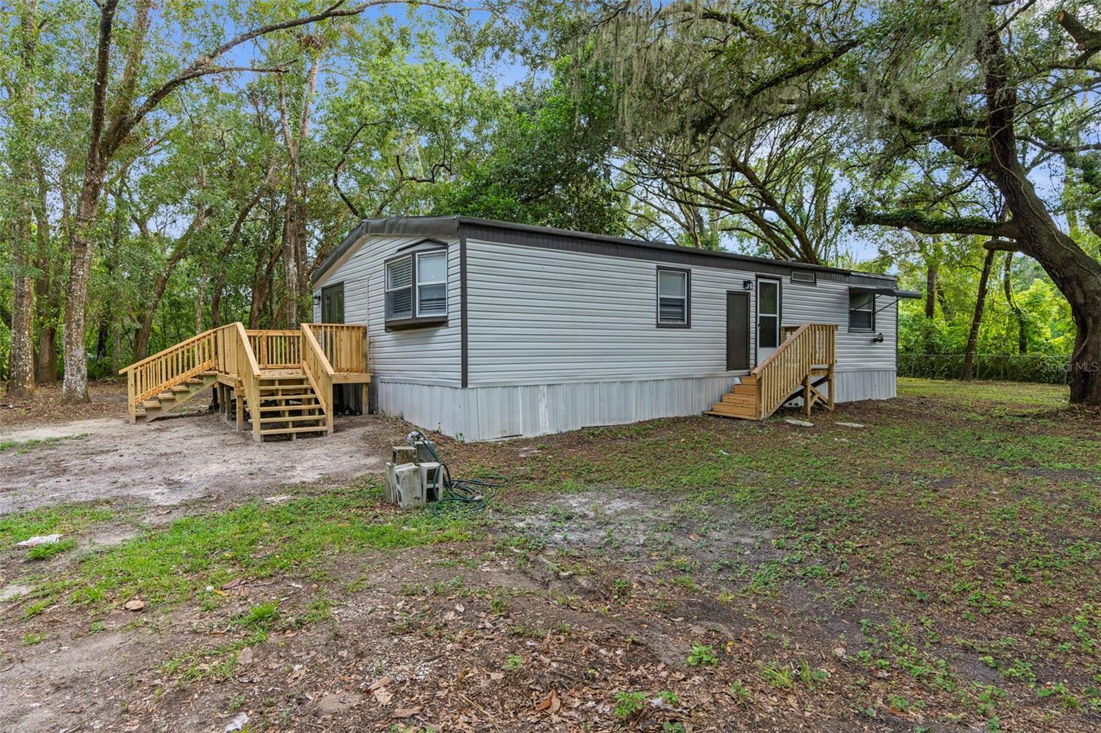 MOVE-IN READY!! SUPER NICE and CLEAN!! REMODELED!! 3/2 double wide nestled in the trees on a DOUBLE lot (half acre) and completely fenced and gated!! Located near the Suncoast Parkway and County Line Road for quick and easy access to everything!! 3 bedrooms + 2 full bathrooms + inside laundry room + deck (20x11) + metal roof in 2009 + AC 2020 + truly nestled in the gorgeous canopy of large live oak tress for complete privacy and completely fenced and gated for security! Lots of yard space for the family and pets!! 

REMODELED Kitchen with new white shaker cabinets, countertops, and stainless steel appliances! All new luxury vinyl plank flooring! Newly painted inside...so it's nice and clean! Large master bedroom with ensuite bathroom and walk-in closet. Also, one of the additional bedrooms is extra large with a walk-in closet, as well. 

1,188 sq feet living space! Zoned R1A. NO FLOOD!! NO HOA!! So bring your camper, RV, boat, ATVs...lots of place to park - add a carport or detached garage to make it your own! The double lot is nice and square (144' x 150')! 

No neighbors right on top of you and the home feels very private and secluded even though you are so close to everything...shopping, restaurants, the parkway to Tampa, Anderson Snow Water Park, soccer, baseball, and softball fields! 

Home is a 1980 and was moved there in 2020. If you are not a cash buyer, ensure you are using a lender that will finance on a manufactured home that was relocated. If you don't have one...ask! Move right in! Come see it today!!