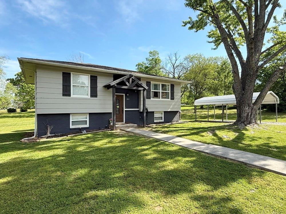 Updated Home on Spacious Lot in El Dorado Springs, MO for Sale. 
Don’t miss this home! From the curb appeal to the updated interior, this modern home is turn-key ready for new owners. This is a 2-story, split-entry home with over 1,700 finished square feet, making it both attractive and functional. The main level features the spacious living room, beautifully upgraded kitchen, 2 bedrooms, and 1 full bathroom. The kitchen features stainless appliances, newer cabinetry, an island with storage and bar dining, and a nice sized pantry. The kitchen walks out to a deck to extend your kitchen/dining space outdoors. The living room is a comfortable size and the entire main level features luxury vinyl plank flooring and vinyl windows. The lower level of the home features another living area (currently used as a homeschool classroom), 2 bedrooms, and a 2nd bathroom with utility room. The home sits on a spacious corner lot with a great yard and a few mature shade trees.  Added bonuses to the exterior are the carport and a storage building. This is an excellent home at a competitive price! Schedule a showing today!