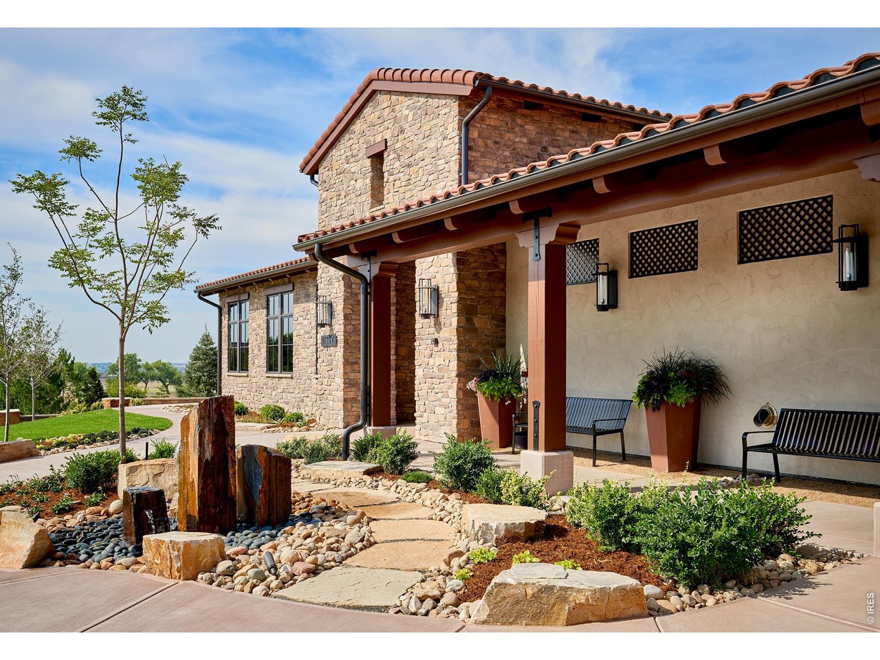 Comfort, Value and Lifestyle abound in Harmony Club! Nestled alongside a generous greenbelt and backing to the Harmony Club golf course, this immaculate end-unit townhome offers beautiful Rocky Mountain Front Range views paired with a peaceful setting that is second to none. Featuring large windows on three sides that fill the space with natural light, this home seamlessly combines luxury and function-complete with an oversized finished two-car garage offering plenty of extra room for your golf cart and custom storage cabinetry. From the moment you step up the walkway adjoining two lovely patios for you to enjoy the outdoors, you are welcomed into an open and inviting floor plan. The beautifully appointed kitchen boasts custom cabinetry extending to the ceiling, elegant crown molding, under-cabinet lighting, and pristine quartz countertops. It flows effortlessly into a generous dining area and a vaulted great room anchored by a stunning gas log fireplace. Entertain with ease from the kitchen to patio with sliding glass doors right off the patio or stroll down the flagstone pathway to the raised deck to watch the golfers play. Upstairs you'll find a spectaular loft that makes a great rec space or home office plus you'll find two spacious bedrooms-all with great views. The fully finished lower level offers exceptional space for entertaining as well. Enjoy the dedicated wet bar, thoughtfully designed with built-in shelving, a wine chiller, and a separate beverage fridge for easy hosting. The finished basement also offers another bedroom and bath providing privacy for family or guests and two generous storage rooms ensuring a place for all your treasures. Follow your passion with golf, swimming, tennis, pickleball, basketball, all in your own community or just relax the day away enjoying fabulous food and views at the Pavillion. Top tier dining at the clubhouse is a real standout so join your neighbors and raise a glass to your new home.