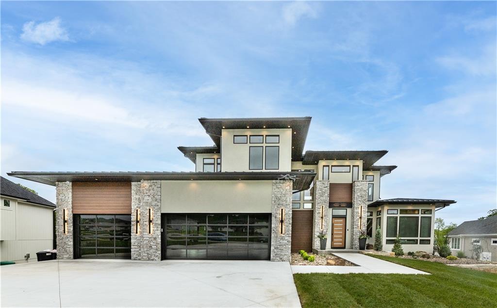 This lakefront masterpiece is the perfect combination of a contemporary and prairie style home! This home is your new "Retreat". When you enter "The Retreat" you are greeted with 26ft ceilings in the main living room with a custom 11ft metal linear fireplace, which gives it an open yet cozy feeling. The main floor kitchen is a Chef's dream kitchen with large refrigerator, freezer, gas stove and cooling drawers. Not to mention, the Butlers pantry offers a over-sized pantry, coffee station and beverage cooler. The Retreat displays 132 windows that shine from natural sunlight and many beautiful Lake Winnebago colorful and glowing sunsets. You will also find a 2nd floor floating metal staircase that will lead you to the basement with 12 foot ceilings. "The Retreat" is the perfect space for entertaining!! There is a movie theatre for movie night, a gym for your daily workouts, LED lit wine room and more! Also, It has custom bar, serving kitchen, and 80" TV that is all perfectly situated in the open lower living room space, where you look out onto the infinity edge pool, hot tub and lake...you truly have your own outdoor oasis. The patio has with a custom concrete poolside table, 2 outdoor fireplace spaces that beautifully lead to a 20X30 covered dock. Come by boat or car to see this one-of-a- kind masterpiece!  Agent/Owner