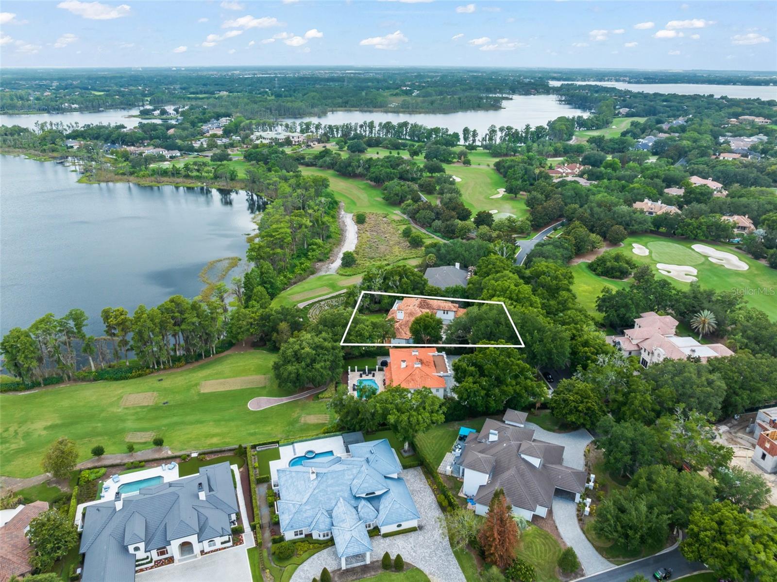 Under contract-accepting backup offers. Located along the 2nd tee of Isleworth's renowned championship golf course, this beautiful golf-front estate offers an exceptional location within the gates.  The five-bedroom home features offers a spacious and open floor plan of more than 5,900 square feet overlooking the serene golf and water vistas. .
