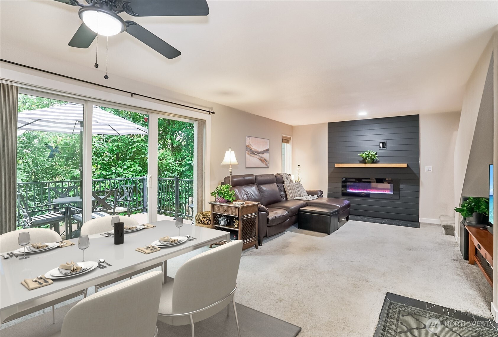 Charming Townhome with modern amenities. This is a two-bedroom two bath unit with detached single car garage. New front door and tile entry. Main level offers open concept floor plan. New paint, trim and lighting fixtures throughout. This home is welcome and inviting. Kitchen has lots of cabinets, new butcher block countertops and kitchen sink & faucet. Living room has new raised electric fireplace providing a cozy atmosphere. Sliding glass door lets in plenty of natural light. Upstairs has primary bedroom, full bath and guest bedroom. All bathrooms updated with new flooring, lighting and vanities. Private back deck with trek decking and new railing. This end unit backs up to greenbelt. Recently replaced roof. Easy access to Kent Station.