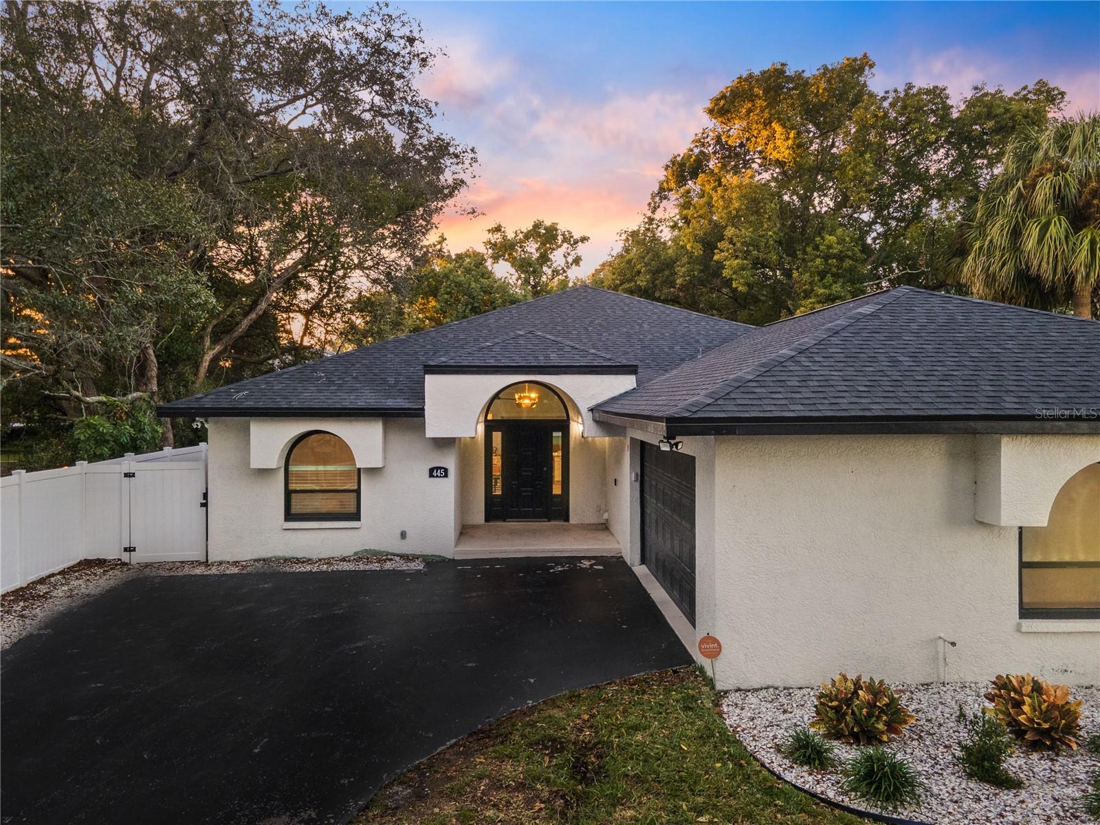 Welcome to 445 Wexford Leas Blvd, a fully remodeled 4-bedroom, 3.5-bathroom home located in the sought-after community of Palm Harbor. Over the past few years, this home has undergone extensive updates, making it move-in ready and equipped for modern living. Major updates include LVP flooring, an updated kitchen with quartz countertops and a marble herringbone backsplash, updated bathrooms, recessed lighting, fresh interior and exterior paint, and a new roof all completed in 2022. Further improvements made include PGT hurricane-rated windows and sliders, a resurfaced PebbleTec pool, travertine tile on the lanai and side porch, an irrigation system, professional landscaping, and a white vinyl privacy fence. A new water heater was installed in 2023, and the HVAC ductwork was redesigned for improved efficiency. The home features a well-designed three-way split floor plan, with a spacious master suite that includes a walk-in closet and a beautifully updated master bathroom. The oversized laundry room and additional half-bath are conveniently located near the side-entry garage, which is currently converted into living space but can easily be restored. Situated on an oversized 0.35-acre lot with no HOA or deed restrictions, this home is located in Flood Zone X, 50 feet above sea level, meaning no flood insurance is required. It sustained no damage during recent hurricanes. The property is also within an A-rated school district, making it an excellent choice for families. Currently operating as a successful short-term rental with strong revenue potential, this home is being sold fully furnished for a seamless transition, whether as a personal residence or an investment. Schedule your showing today!