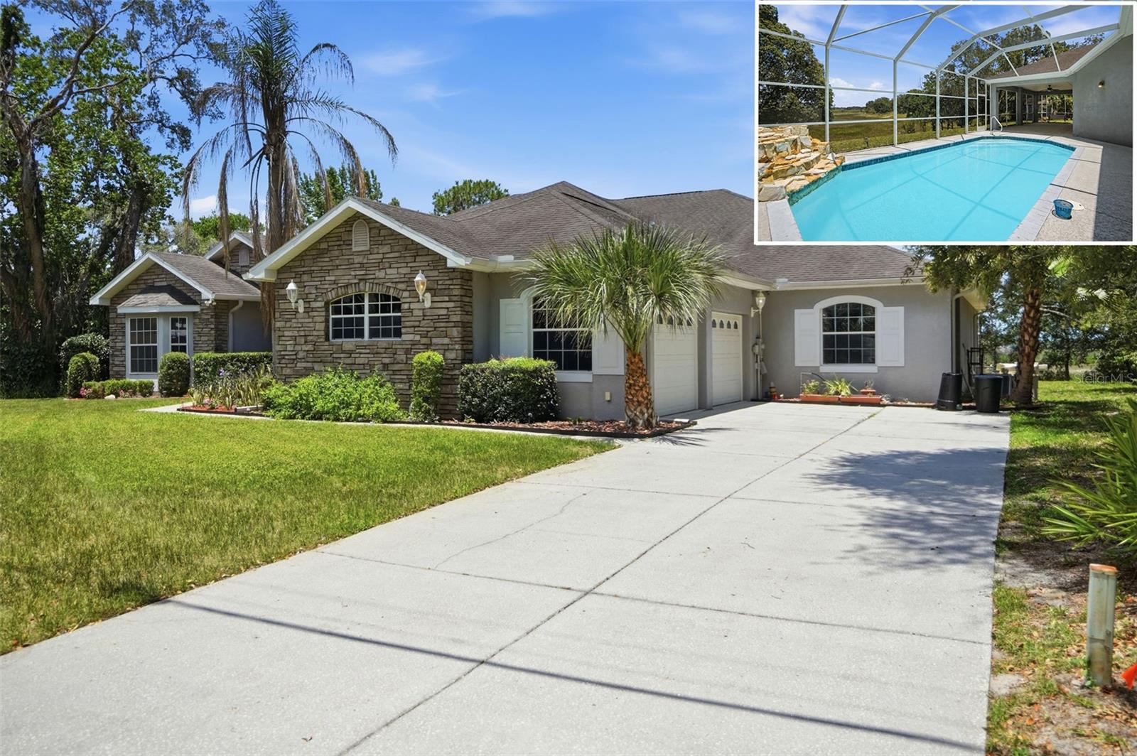GORGEOUS STONE-FRONT CUSTOM POOL HOME (WITH NEW ROOF PRIOR TO CLOSING) with mother-in-law suite with its own FULL Kitchen, full bathroom, large walk-in closet, and combined studio bedroom and living room!! All together, the custom home offers 3 bedrooms + large office (can be a 4th bedroom) + large library with attached office (can be converted into a 5th bedroom) + 3 full bathrooms + a half bath for guests + 4-car garage + PRIVATE POOL with rock waterfall and screen enclosure + large covered lanai + the home is nestled on a lot and a half which is over a half of an acre with NO REAR neighbors to look at or to look at you - nice long distance views of nature!!  The lot technically has 150' of lake frontage. The lake is dry; been in a drought. It may come back, but has not had water in years. Extra long driveway for additional parking! NO FLOOD! NO HOA!  This home offers so much!! The large kitchen offers real wood cabinets with granite countertops, prep island, large breakfast bar for extra seating, and large wet bar for coffee/wine/serving area with gorgeous glass cabinets and mini beverage refrigerator! Stainless steel appliances! The kitchen is open to the large family room with large glass sliders and high tray ceiling making the home feel light, bright, and very spacious!! Split floor plan gives privacy to the master suite!The master suite is impressive and spacious with glass sliders overlooking the pool (with no one to look at) + large walk-in closet with built-in shelving + extra large ensuite bathroom with an incredible amount of upgraded Corian countertop space with dual sinks and lots of cabinets for extra storage space + soaking tub + separate walk-in shower + toilet room for privacy.  The second bedroom is a mini-master suite with its own attached bathroom with large walk-in closet!The mother-in-law suite is a dream come true for the generational family!  It closes off separate from the house for complete privacy!! It has a full kitchen with refrigerator, oven/stove range, and microwave! Real wood cabinets with lots of storage space!! It has its own full bathroom with walk-in shower, private toilet room, Corian countertops and real wood cabinets! The master closet is enormous...room for everything! The bedroom area is sparated from the living room with a half-wall with shelving for storage! The living room area has glass sliders to the outside lanai and pool and bedroom area has its own large windows overlooking the backyard with no neighbors and long distance views.The office is very large: add a closet and it's easily a 4th bedroom if needed. The library is impressive for a reading room with it's own attached office. You can turn its office into a closet for a 5th bedroom if needed.  Large formal dining room and foyer! The large covered lanai also offers an additional screened in area for gardening or a small pet area. The home is close to everything!! Shoppes, restaurants, hospitals, schools...everything!! Less than 10 minutes to kayaking, paddle-boarding, and swimming with the manatees in the clear Weeki Wachee River or enjoying a day at Buccaneer Bay Water Park!! 15 minutes to the sunsets at Pine Island, boating and fishing!! Less than 10 minutes to the Suncoast Parkway for quick and easy access to Tampa International Airport and for all the fun that Tampa Bay has to offer!! 1 hour + to TOP US BEACHES!! 1.5 hours to Disney World and Universal Studios and all the theme parks!!