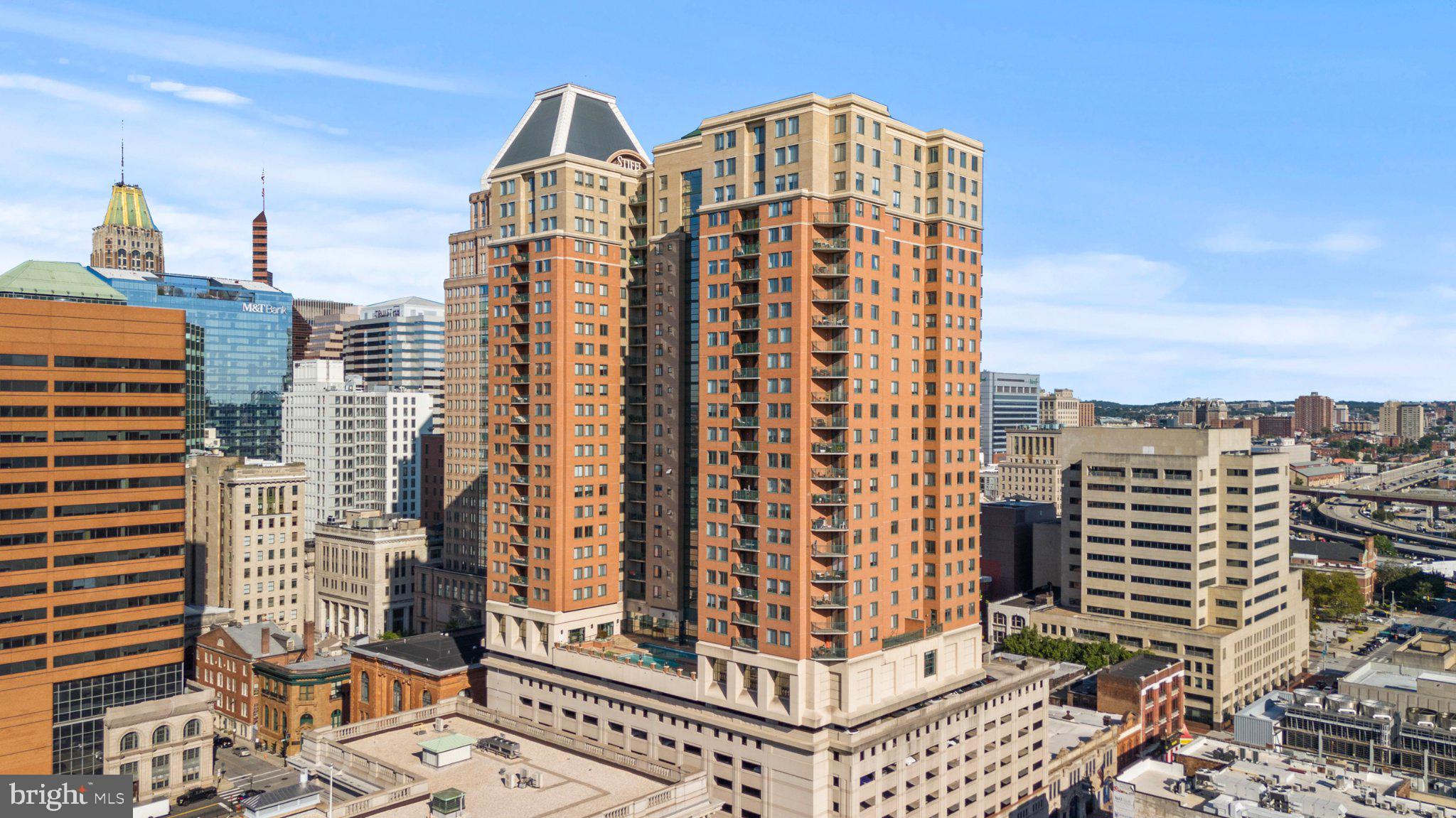 The Charles floor plan offers one of the largest living spaces in the building and is filled with natural light thanks to windows on three sides. Enjoy a private corner balcony with exceptional privacy, offering views that can't be seen by neighboring residents.The spacious primary suite features double closets, including a walk-in closet, a soaking tub, and a separate walk-in shower. Additional highlights include in-unit stackable laundry, a granite and stainless steel kitchen with gas cooking, and an open-concept layout with a breakfast bar that provides additional seating and dining space.The southern exposure showcases breathtaking views of Baltimore's Outer Harbor and provides a front-row seat to the city's spectacular Fourth of July fireworks.Residents enjoy the security and convenience of a luxury high-rise with a 24-hour front desk, parking attendant, on-site management, rooftop pool, fitness center, community lounge, business center with internet access, and secure elevator access. This is city living at its finest.