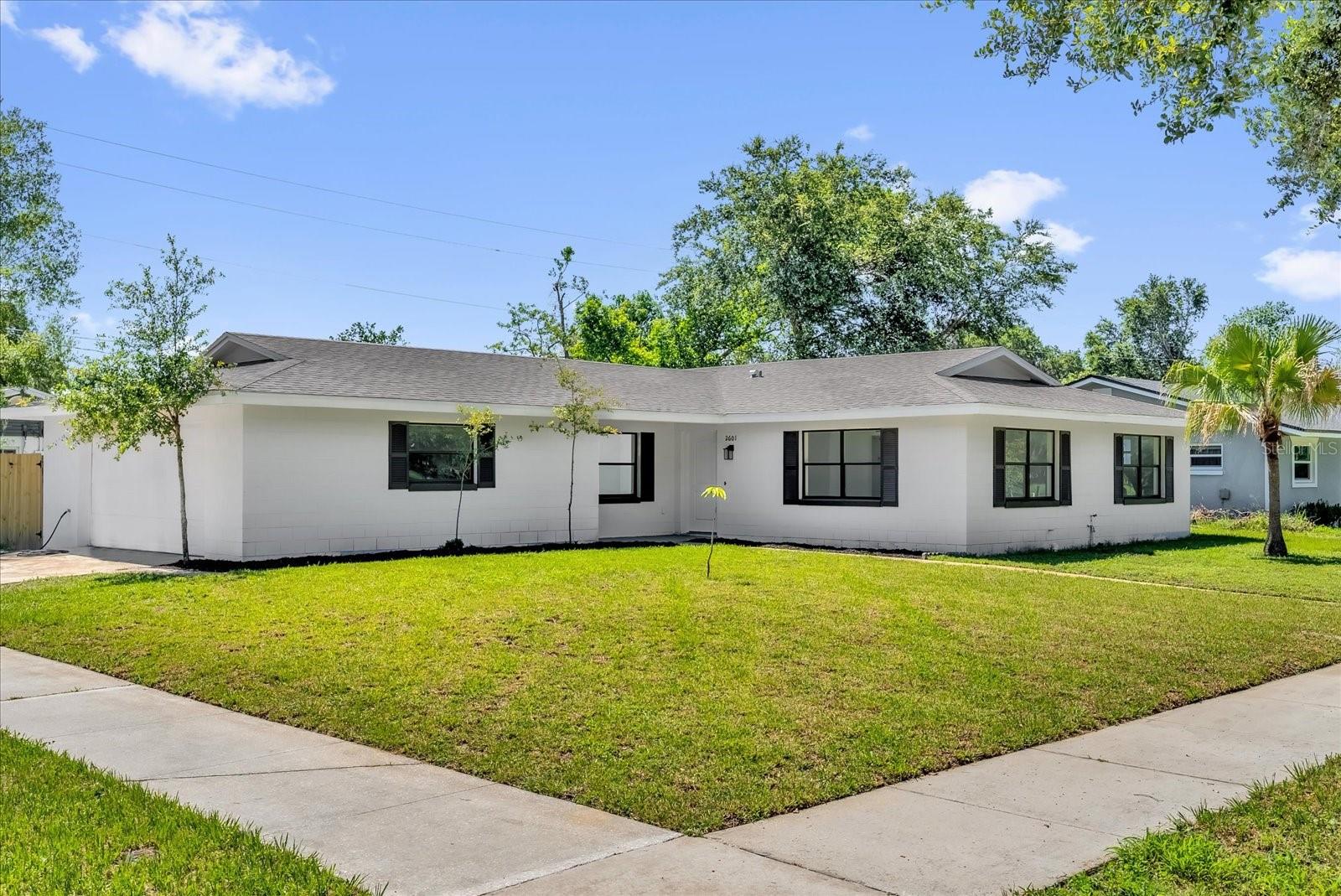 Under contract-accepting backup offers. **NEW** - No HOA - Corner lot - (2025 Roof, A/C, Water Heater, Plumbing & Electrical) Welcome to this fully renovated corner lot home in the heart of Orlando, just 10 minutes away from Downtown Orlando! As you enter you are greeted by an open-concept living space  with a defined family room with stylish stone countertops throughout the home. This home features 3 comfortable bedrooms, and a sleek ensuite featuring a glass rain shower. The fully fenced backyard offers the perfect private space to relax or entertain. Even better, the home is perfectly positioned just steps from your local middle and elementary schools, and directly across from Clear Lake Park and the sparkling Clear Lake—offering 358 acres of open water access for boating, fishing, and lakeside relaxation.