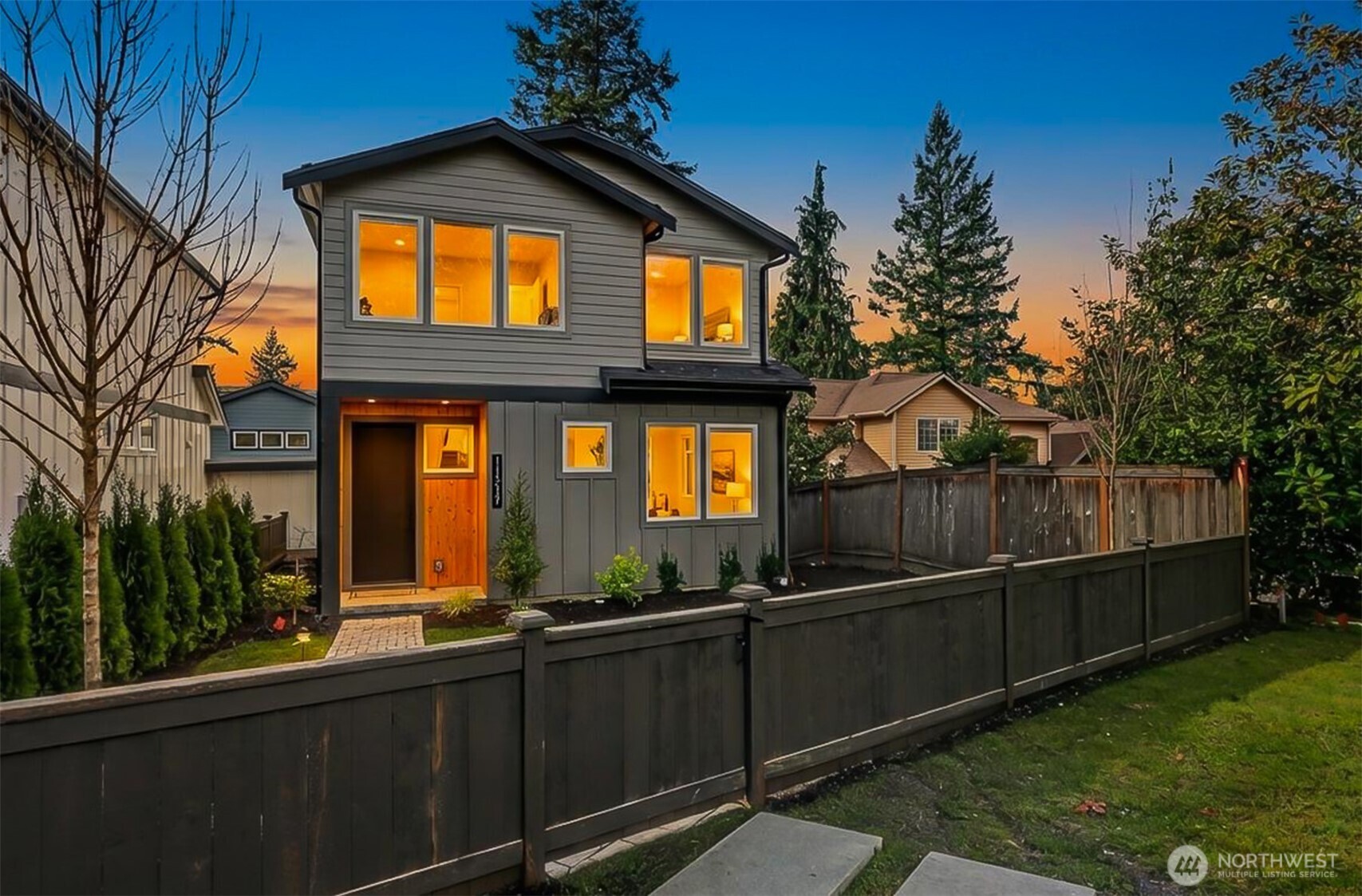 Experience contemporary Northwest style paired with timeless luxury in this stunning new construction home. The main level showcases a gourmet kitchen with a quartz island, custom cabinetry, premium appliances including a double oven, and a sleek wet bar. Enjoy a formal dining room, an inviting living room with a fireplace, and a dedicated office—ideal for working or studying from home. Upstairs features vaulted ceilings, four bedrooms, two full bathrooms, and a convenient laundry room with washer and dryer included. The spacious primary suite offers a spa-inspired bath with a soaking tub, oversized shower, heated floors, and a walk-in closet. The lower level provides additional flexibility with a second living room or media space, a full bath, and access to a patio and fully fenced backyard—perfect for relaxing or entertaining. A mudroom connects to the EV-ready two-car garage. For added comfort and peace of mind, the home is also equipped with a gas-powered generator for backup power during outages.