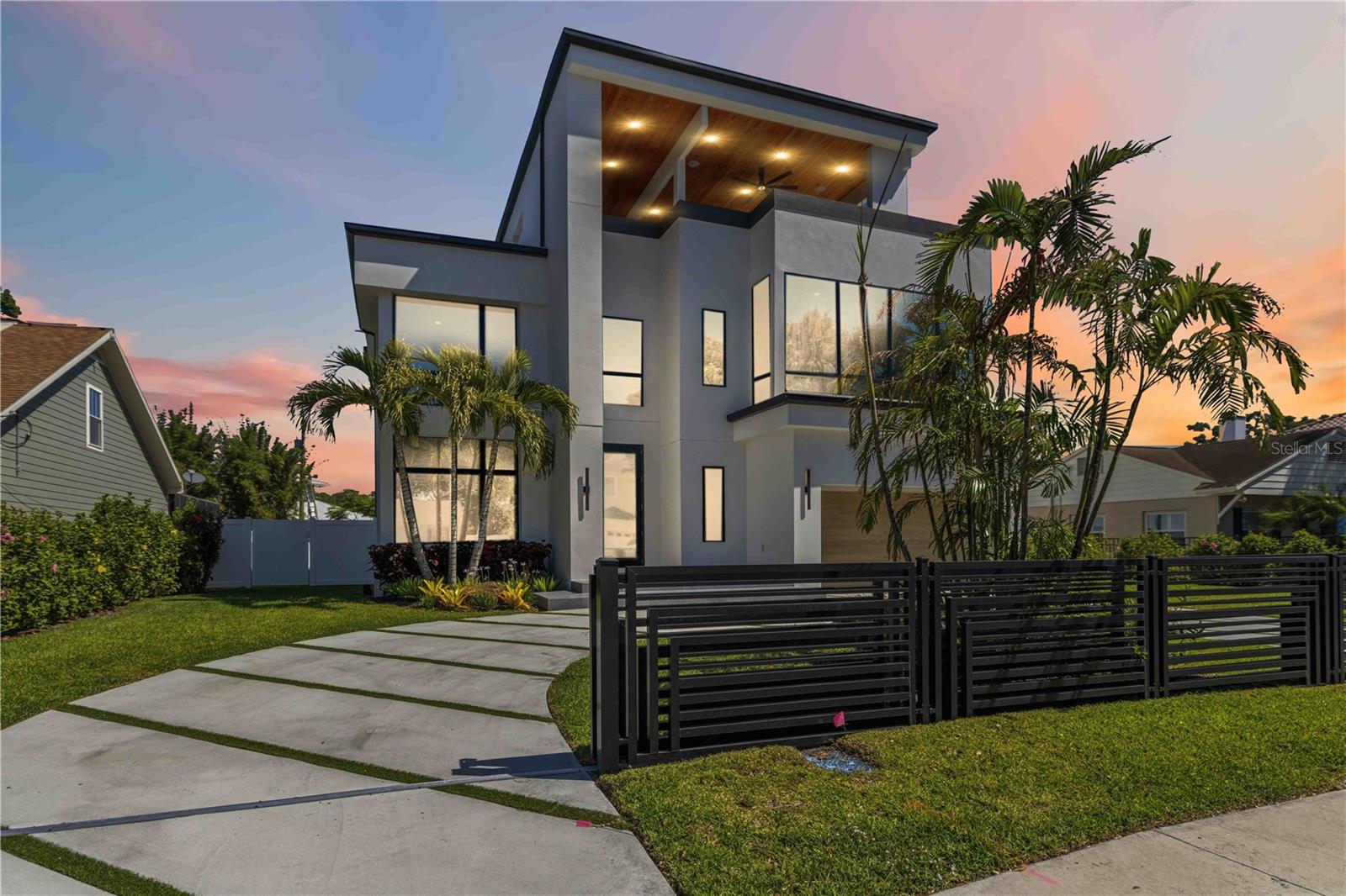 Welcome to 4109 W Watrous Avenue, a striking newly constructed three story residence in the heart of South Tampa's prestigious Palma Ceia West neighborhood. Located in the top rated Mabry Elementary, Coleman Middle, and H.B. Plant High School, this extraordinary Five bedroom, five and a half bathroom home delivers the scale, sophistication, and thoughtful design that today's most discerning buyers and investors demand. Set on a generous 75 x 138 lot in the established Morrison Court subdivision, this home was built from the ground up by Cigar City Builders and completed in 2025, offering modern construction, current building codes, and premium finishes throughout with none of the deferred maintenance concerns of older South Tampa inventory. Step through the entry into soaring high ceilings that flood the living spaces with natural light. Two distinct living areas and a sizable dining space provide the rare flexibility to entertain on a grand scale while maintaining intimate everyday comfort for the entire family. A dedicated great room, family room, game room, and exercise room ensure every occasion has its own space. The kitchen is designed around a generous center island and equipped with a built in oven, cooktop, dishwasher, disposal, microwave, and refrigerator. It flows seamlessly into the adjacent living spaces, creating a natural gathering area where conversations move effortlessly from the island to the great room and beyond. The main level primary suite offers a private retreat with a full en suite bath featuring a double vanity and expansive walk in closet. Five additional bedrooms occupy the upper levels, each generously proportioned for family, guests, or flexible use as a home office, media room, or creative studio. Five full bathrooms and one half bath ensure no compromise on convenience.  The home is wired for cable and surround sound throughout. Interior appointments include high ceilings, a wet bar, ceiling fans, dedicated pantry, storage room, screened patio and porch, and a sunroom that invites the outdoors in. Zoned central AC and central heat allow precise temperature control across all three levels. Upper level laundry near the bedrooms and attached garage provide daily convenience. Outside, an in ground pool is set within the expansive fenced backyard designed for the Florida lifestyle: pool days, al fresco dining, and effortless entertaining under the Tampa sun. This home features an elevator for all 3 levels including the bonus room and additional siting area on level 3 with two expansive roof top wrap around decks to enjoy sunrise to sunset. No flood insurance required, offering peace of mind and meaningful annual savings. City water and sewer in place. Within close proximity to Cal Dickson Tennis Center, minutes to Bayshore Boulevard, Bay to Bay, South Howard, Hyde Park Village, Tampa International Airport, Downtown Tampa, MacDill AFB, and Gulf Coast beaches. This is more than a home, it is a legacy asset in one of Tampa Bay's most enduring and appreciating neighborhoods.  Whether you seek a forever home, a high performing real estate investment, or a tangible cornerstone of generational wealth, 4109 W Watrous Avenue delivers on every level.