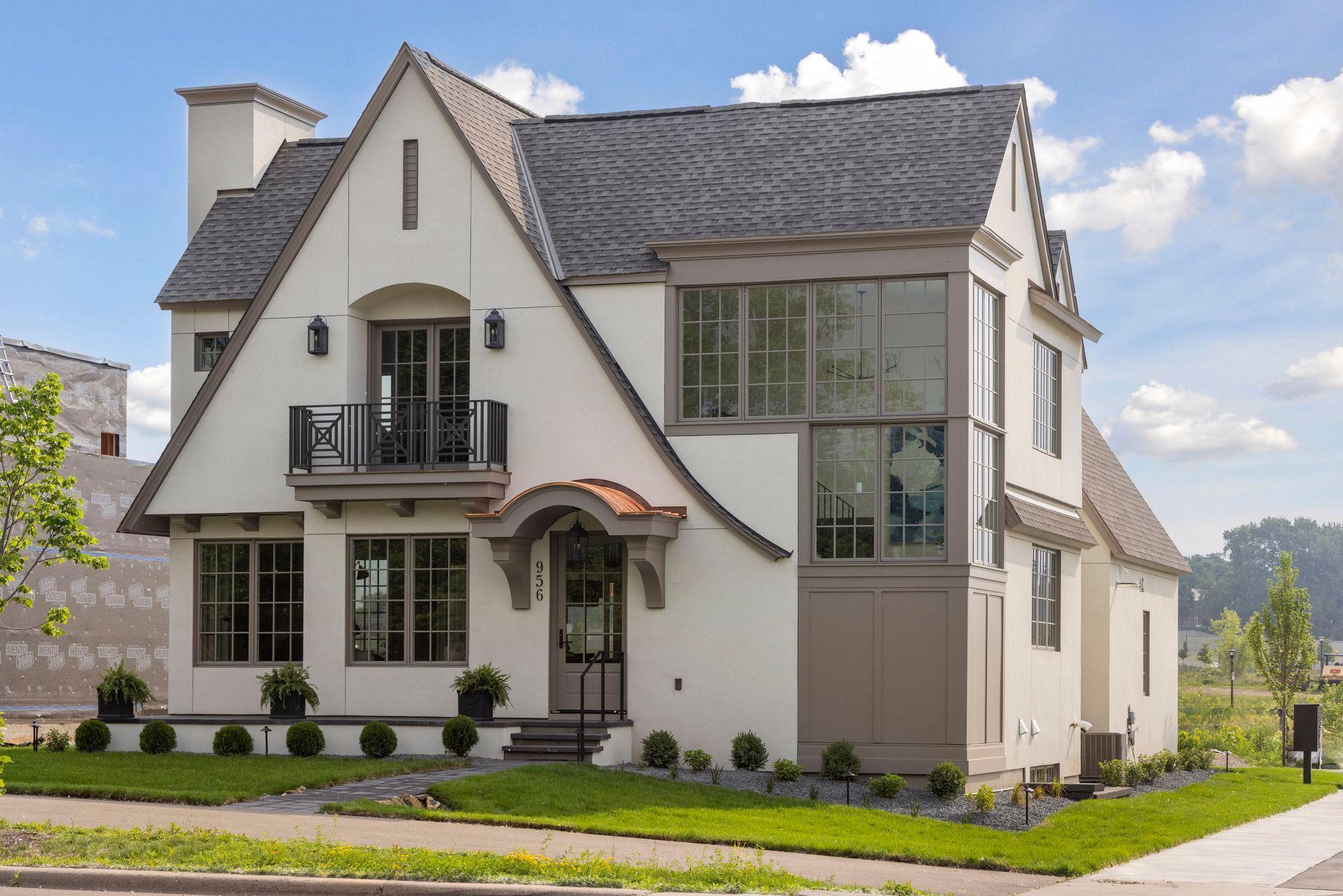 Stunning Modern Tudor in Highland Bridge just completed in June 2025! This custom 4 bed, 5 bath Modern Tudor—built by acclaimed Detail Homes and thoughtfully designed by David Charlez Designs—sits proudly on a coveted corner lot in Saint Paul’s most exciting new neighborhood: Highland Bridge. Here, timeless charm meets modern sophistication in one unforgettable home. Inside, you're greeted by an open-concept layout drenched in natural light, thanks to oversized windows throughout. The gourmet kitchen is a chef’s dream, featuring sleek finishes and a separate walk-in pantry. Step out to the lovely back porch—perfect for morning coffee or evening wine.Upstairs, the spacious owner’s suite is a true sanctuary, complete with a Juliet balcony, large walk-in closet, and a spa-inspired en-suite bath. The finished lower level adds even more living space, with a full exercise room, generous family room, additional bedroom, and bath. Highland Bridge is more than a community—it’s a lifestyle. With over 50 acres of parks, trails, and greenways, it’s Minnesota’s most sustainable and thoughtfully planned neighborhood. And with only 13 lots available, with lot prices starting at $475K, the opportunity to build your dream home here won’t last long. Ready to build your forever home? Let’s talk!