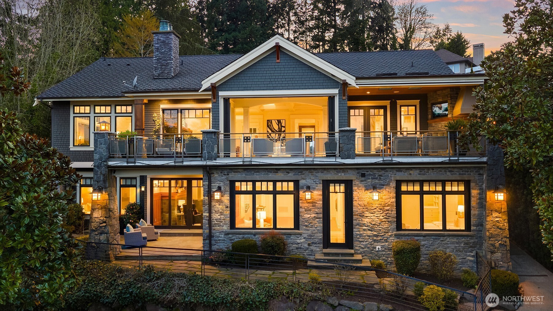 Positioned proudly on the north end of Mercer Island, discover a Modern Craftsman with a charming beachside gust house right at the waters edge.