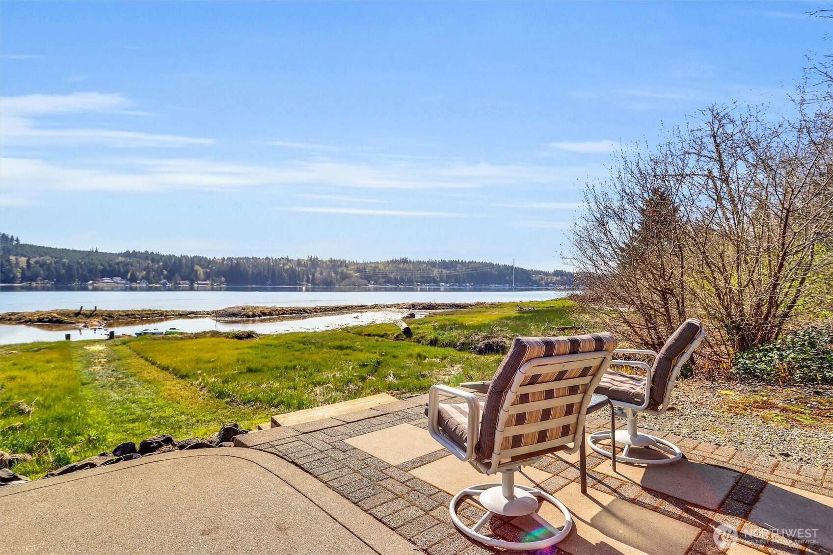 134 feet of rare low-bank waterfront!! 1.4 acres of serene, tree-lined privacy set the stage for effortless coastal living on Case Inlet. Nestled in a private setting, this well maintained single-story retreat invites you to slow down and soak in the rhythm of the water, with panoramic windows framing ever-changing inlet views from the open-concept living and kitchen area.Wake to the call of eagles, unwind at sunset with your favorite drink while herons glide by, deer roam the surrounding landscape, and seals and otters play along the shoreline. Step outside to enjoy kayaking, paddleboarding, or casting a line in calm, protected waters. Stroll the pebble beach in search of clams, oysters, seashells—your own private stretch of the PNW. Offered fully furnished, this pristine 3-bedroom, 2-bath home is truly turnkey—ideal as a waterfront getaway, full-time residence, or income-producing vacation rental. Tucked away yet close to Allyn’s pier, boat launch, dining, shops, golf, as well as Gig Harbor and Belfair with their unique, quaint shops, you’ll enjoy both seclusion and convenience. Case Inlet’s welcoming waters are perfect for motorboats, making it easy to explore or entertain. Peaceful, private, endlessly inspiring—this is waterfront living at its finest. Includes a 1-year home warranty.