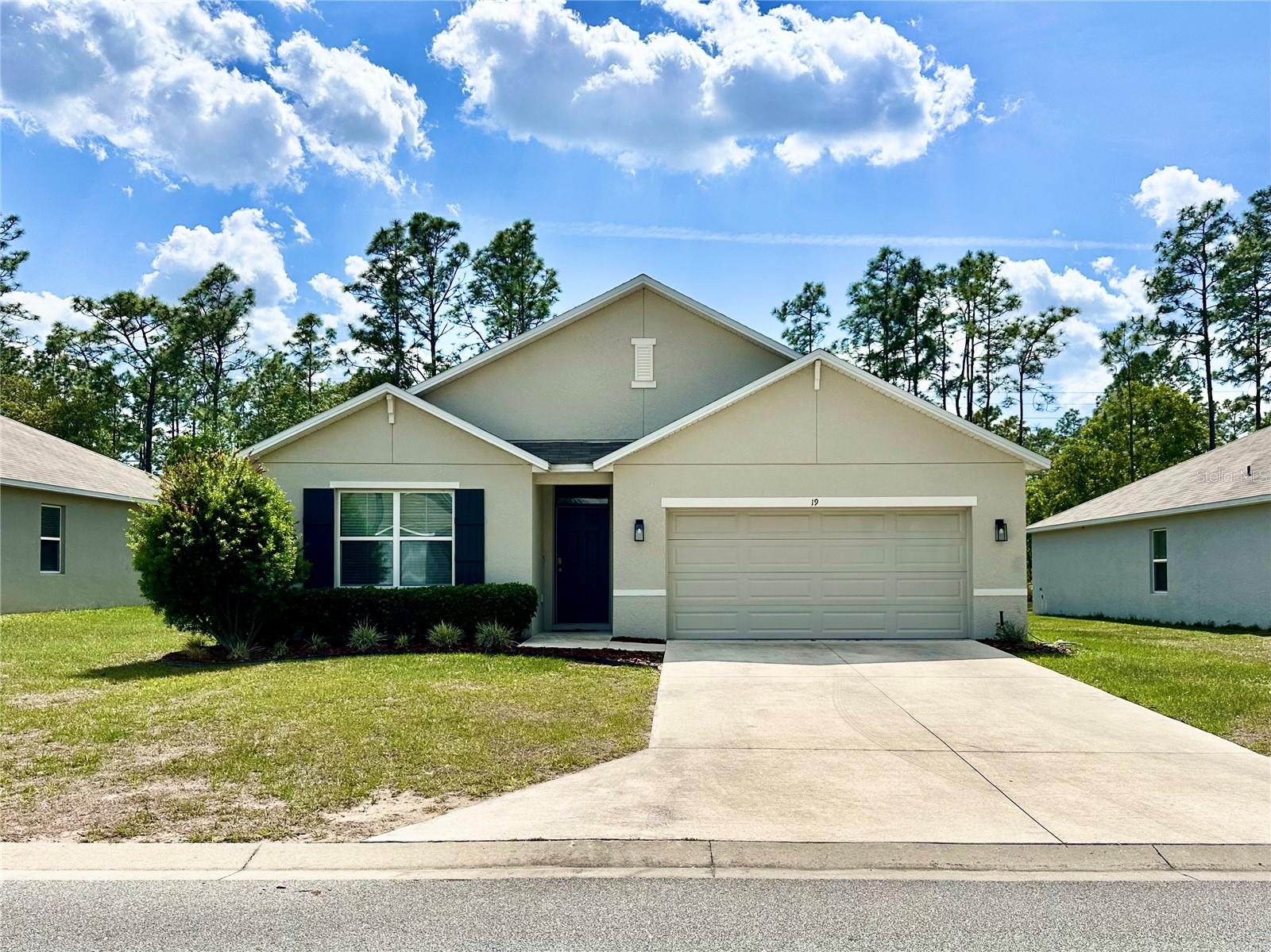 Located in the gated golf community of Lake Diamond North, this 2021 D.R. Horton Cali model offers 4 bedrooms, 2 bathrooms, 1,827 sq ft of single-story living, and a 2-car garage — with smart home features and an irrigation system. Furnishings are negotiable, making this a truly turnkey opportunity. Step inside and the open floor plan does exactly what it should — the kitchen, dining, and living areas connect naturally, making the space feel large and bright. The kitchen anchors the layout with a walk-in pantry and a full appliance package including refrigerator, range, microwave, and dishwasher. Tile floors carry through the main living areas, transitioning to carpet in the bedrooms where it matters most. The split floor plan gives the primary suite its own corner of the home — walk-in closet, en suite bathroom, and real separation from the other three bedrooms. Those rooms share a full bath with tub and shower, each with their own built-in closets. Washer and dryer are included. Out back, the rear porch is the perfect spot to enjoy Florida evenings. Lake Diamond North is an all-ages, gated golf community offering a clubhouse and golf cart-friendly streets — easy living from the moment you arrive.