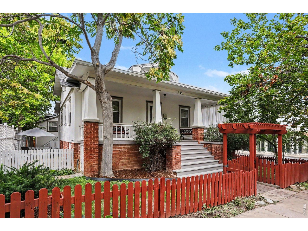 The Allen Residence. Built in 1922 on Boulder's historic Mapleton Hill, this Craftsman bungalow is a legally conforming duplex, income-ready from day one. The main home features original Douglas Fir floors, 6 panel doors, Craftsman casework, 3 beds, 2 3/4 baths, a covered front porch on tapered brick piers, and a skylit finished attic with charming flex space. Tucked below is a fully finished walk-out garden level apartment, a true second unit with its own private, entrance on the east side and separately metered is ready for a tenant, guests, or a standalone private suite. Out back, a detached 3-car garage (rare on this end of Mapleton Hill) is topped by a 612 SF studio currently with a half bath, convertible to full, with light and bright, living space under current Boulder zoning for a third income stream. RMX-1 zoning supports single-family, duplex, or triplex use across the property's two structures. The finished interior living space totals 3,252 SF, with an additional 374 SF of outdoor living space, 612 SF of parking, with a complimentary 120 SF in the storage shed. All major systems have been updated during current ownership, including electrical, plumbing, hot water heat, windows, and roof. Highly walkable location (87 Walk Score) places the Ideal Market, North Boulder Park, Mount Sanitas, downtown Boulder and Pearl Street, Boulder Creek Path, CU Boulder, and an RTD bus route all within an easy walk or bike ride. The home sits next door to one of Boulder's architecturally acclaimed buildings designed by Charles Haertling, originally known as the Boulder Valley Eye Clinic. This is a rare shot at owning a piece of Boulder history with real, flexible upside.