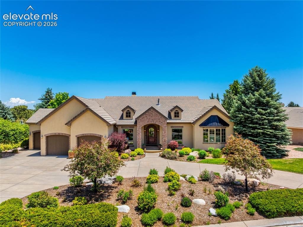 Wonderful Custom Golf Course Home with Pikes Peak Views.This lovely 5 bedroom, 4.5 bathroom home is situated on a quiet street with Golf Course and Mountain views.The main level offers vaulted ceilings, hardwood floors, large windows and plenty of natural light. As you enter the home you are greeted with a large Living Room with gas fireplace, walkout to large covered deck, and pass through bar from the Gourmet Kitchen.The gourmet kitchen offers an eat-in breakfast nook with gas fireplace, plenty of countertop space with large island, gas cooktop stove,and stainless appliances. The main level master suite provides walkout to deck, gas fireplace, en-suite bath with double vanityand large shower, double vanity, and large walk-in closet.Also, on the main level are an additional bedroom with en-suite bath, formal office, large laundry room, and powder room.The walkout lower level continues the wonderful amenities provided by offering a large recreation room with gas fireplace, wet bar,and walkout to private covered patio. The lower level grants3 additional bedrooms all of which offer en-suite bath access.There is also the ability to have on-site storage with the large utility and electrical rooms which are perfect for organization.