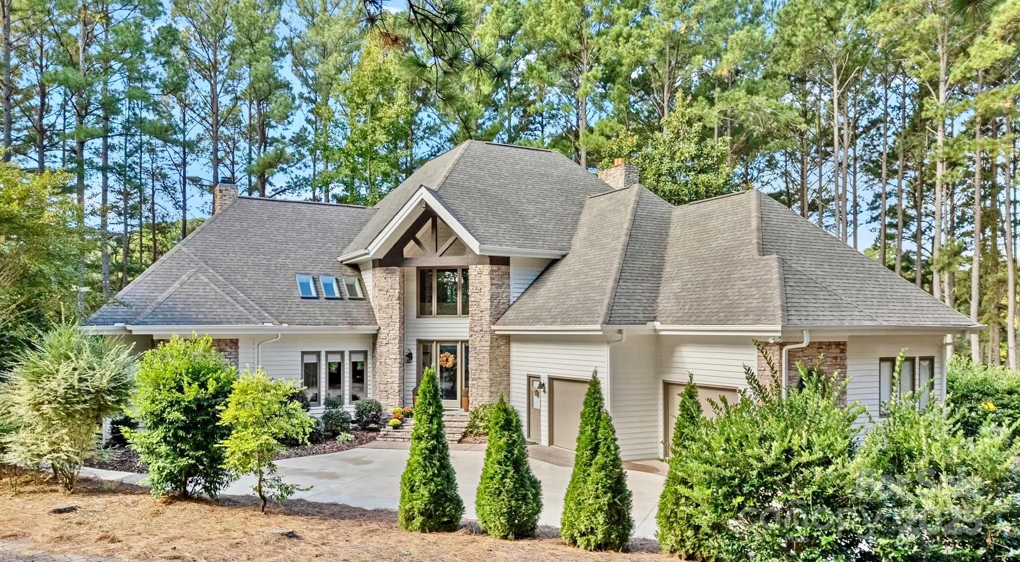 Nestled within the prestigious Uwharrie Point community, this stunning stone and cedar two-story home sits inside one of North Carolina’s most breathtaking settings—directly on the renowned Old North State Golf Course and surrounded by the pristine waters of Badin Lake. With more than 5,000 acres of lake fun and recreation framed by the Uwharrie Mountains, this gated community offers a rare blend of resort-style living and natural beauty.

Inside, discover a fully renovated kitchen with custom cabinetry, stone countertops, and high-end appliances—perfect for everyday living or entertaining. The primary suite on the main level offers a spa-inspired bath and access to a screened-in porch, the ideal place to enjoy your morning coffee while soaking in peaceful golf course views. The family living area, den, and primary suite each feature gas log fireplaces, creating warmth and ambiance throughout the home.

Upstairs features two additional bedrooms and a flex room that can serve as a bonus, office, or guest suite. Natural light fills every space, highlighting the home’s elevated position and its breathtaking fairway views.

When asked what they’ll miss most, the sellers shared, “It’s the sunrises and sunsets—the way this home sits slightly higher lets you take in the full beauty of the community.”

Enjoy all the benefits of gated living with world-class amenities, lake access, a community marina, and the charm of nature surrounding you. Whether relaxing on the back porch or exploring the neighborhood trails, every moment here feels like a retreat.