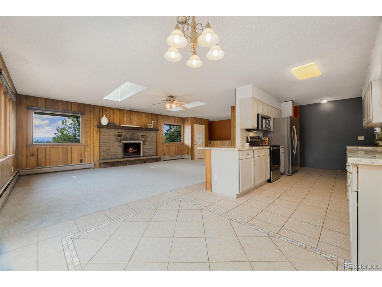 MAJOR PRICE IMPROVEMENT-NOW OFFERED AT $745,000! Welcome to mountain living in beautiful Estes Park. Situated on a peaceful 0.43-acre lot, this 3-bedroom, 2-bath home offers 1,836 finished square feet with comfortable living areas on both the main and lower levels. Skylights bring natural light into the main living area, while the spacious kitchen features granite countertops and ample workspace. In addition to the new carpet, the seller will have the interior freshly painted. Additional highlights include a freshly painted wraparound deck, an attached 2-car garage, an extra-wide driveway and no HOA. Enjoy a peaceful Colorado mountain setting with convenient access to downtown Estes Park, Rocky Mountain National Park, hiking, fishing, shopping and dining. Schedule your private showing today!