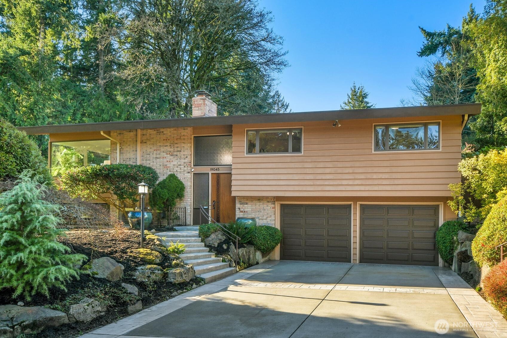 Exceptional mid-century home on shy 1/2 acre lot will knock your socks off! Enjoy clean lines & extensive woodwork including newly refinished oak flooring. Enormous picture windows seamlessly blend the outdoors w/this modern design & provide incredible views. Kitchen offers an abundance of cabs & drawers w/pull-out shelving & pantry. Large primary suite includes a comfy sitting area + adjoining bath & light-filled sliders to an amazing view deck. There’s also a 2nd deck off the dining rm. Spacious rec rm offers versatility depending on your personal needs. Additional features; Hunter Douglas blinds, 2 fireplaces & huge storage rm behind garage. Adjacent lot to South owned by seller & would consider selling or even renting w/option to buy .