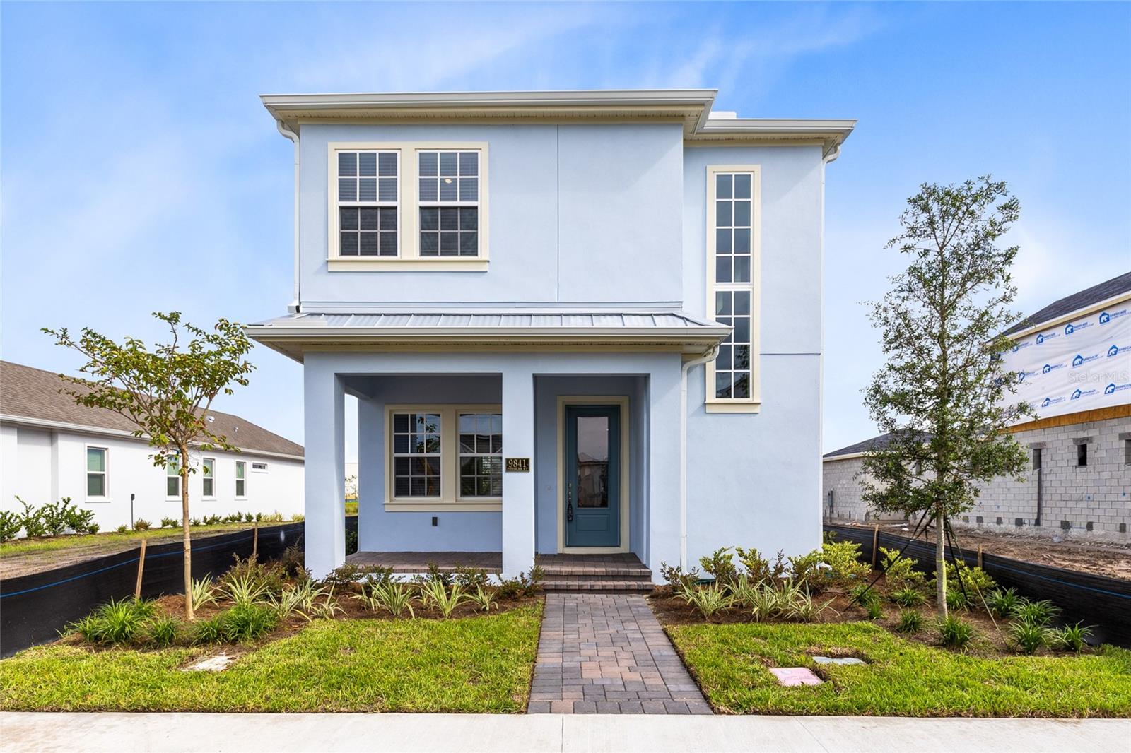 This stylish 4-bed, 3.5-bath home with a full 1-bed, 1-bath garage apartment is set in Lake Nona’s most sought-after community. The welcoming blue exterior and covered front porch create instant curb appeal, leading you inside to a bright and open interior.

The main level features a seamless flow between the living, dining, and kitchen spaces, filled with natural light. Neutral tile flooring runs throughout, complementing the fresh modern design. The chef’s kitchen offers white shaker cabinets, quartz countertops, stainless steel appliances, a sleek vent hood, and a spacious island with bar seating. French doors extend the living space outdoors to a private courtyard-style patio, ideal for entertaining.

Upstairs, the owner’s suite feels like a retreat with a dual-sink vanity, quartz counters, abundant storage, and a large frameless glass shower. Two additional bedrooms, a full bath, and a versatile loft complete the second floor, providing comfort and flexibility for family or guests.

The detached garage apartment includes a full kitchen, living room, bedroom, and bath—perfect for visitors, multigenerational living, or rental income.

Laureate Park isn’t just a neighborhood—it’s a lifestyle. Enjoy access to the Aquatic Center, LP Fit gym, playgrounds, and over 44 miles of trails. Minutes from Medical City, Nemours, the VA Hospital, Lake Nona Town Center, dining, shopping, and with easy access to Orlando International Airport, USTA National Campus, theme parks, and beaches.

This home blends modern design, function, and community living. Schedule your private tour today!