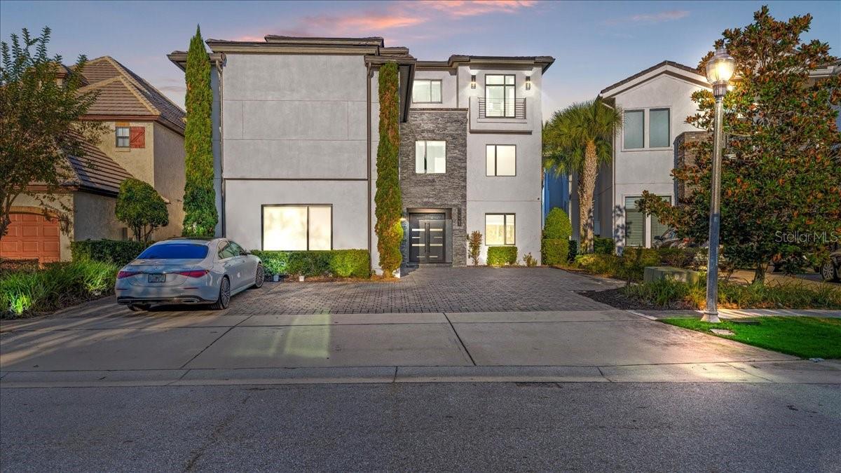 Experience elevated luxury living with this turnkey, three-story masterpiece featuring 10 bedrooms, 11 full baths, and 3 half baths, designed from the ground up to function as a premier vacation and income-producing estate. This residence comes fully furnished and professionally decorated, offering an immediate high-end rental opportunity with no additional upgrades required. Extensive enhancements, including impact-rated windows and doors, ensure exceptional quality and comfort throughout. The interior showcases expansive living and entertainment spaces, including a large billiards lounge, a private state-of-the-art movie theater, and a vibrant multi-room game and arcade area suited for guests of every age. Multiple themed and luxury bedroom suites, along with the home’s thoughtful design across all three levels, create a resort-style experience unmatched in the community. From the top-floor balcony, enjoy stunning panoramic views overlooking the Jack Nicklaus-designed 14th Green, perfectly complementing the home’s five-star ambiance. Situated on one of the largest homesites in the highly sought-after Legend’s Corner neighborhood, this property stands among the most impressive offerings in Reunion Resort. Residents and guests enjoy access to world-class amenities, including championship golf courses, a large water park with a lazy river and slides, tennis and golf centers, fine dining venues, a spa, and multiple gated entrances. Located just minutes from major attractions, this home delivers the perfect blend of luxury, lifestyle, and investment potential. Properties of this caliber rarely come to market, making this an exceptional opportunity within Reunion Resort.