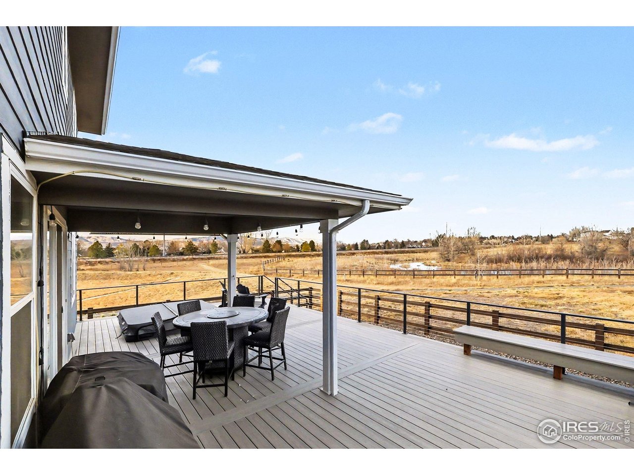 Experience unparalleled privacy and breathtaking natural beauty in this stunning two-story residence, perfectly situated on a quiet cul-de-sac. Low HOA at $49/mo and NO METRO TAX! This rare lot sides and backs directly to open space, offering a serene pond and sweeping panoramic mountain views that serve as the ultimate backdrop for Colorado living. The heart of the home is a bright, airy floor plan flooded with natural light from an abundance of windows, featuring premium upgrades like quartz countertops throughout, upgraded flooring, and a cozy gas fireplace. The gourmet kitchen is a chef's dream, showcasing upgraded 42" soft-close cabinetry, Gas range/oven, Quartz island and countertops, and a seamless flow into the living areas. Designed for versatility, the main level includes a dedicated bedroom and full bath-ideal for a guest suite, next-gen living, or a private home office. Upstairs, you'll find four additional bedrooms, large laundry room, Primary Suite boasts a huge Walk-in Closet, plus a generous loft, providing ample space for work and play. Outdoor entertaining is elevated to an art form on the extended covered deck, which features a built-in hot tub and two dedicated gas lines for your grill or fire pit. Modern conveniences abound, including a tankless hot water heater, central AC, and a massive 3-car tandem garage. Every detail has been considered in this meticulously maintained home; please see the documents tab for the floor plan and property videos. Garage is EV Charger ready.